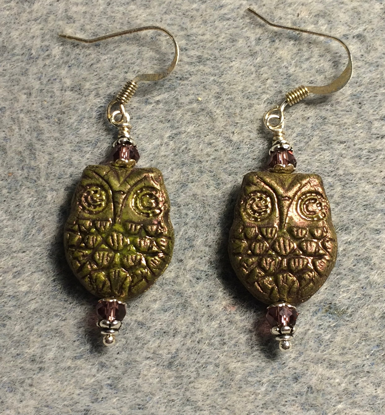 Olive green (with purple wash) Czech glass owl bead earrings adorned with purple Chinese crystal beads.