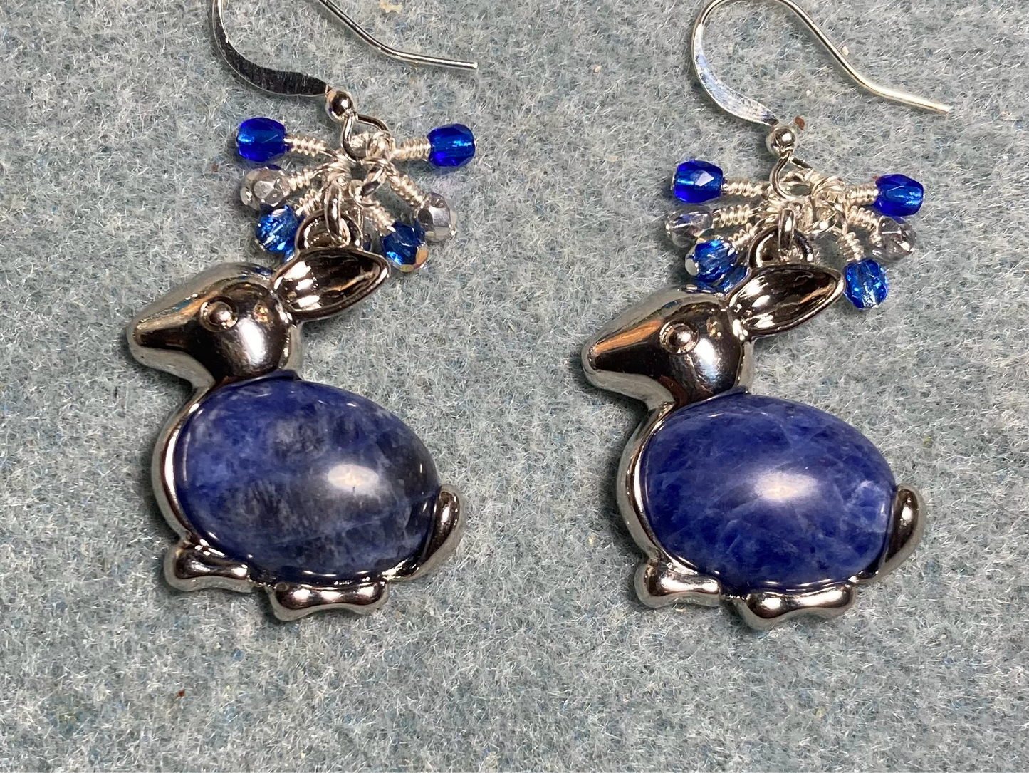 Large silver and blue sodalite gemstone rabbit charm earrings adorned with small dangling blue and silver Czech glass beads.