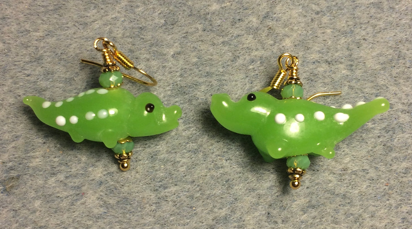 Opaque lime green lamp work spotted alligator bead earrings adorned with lime green Chinese crystal beads.