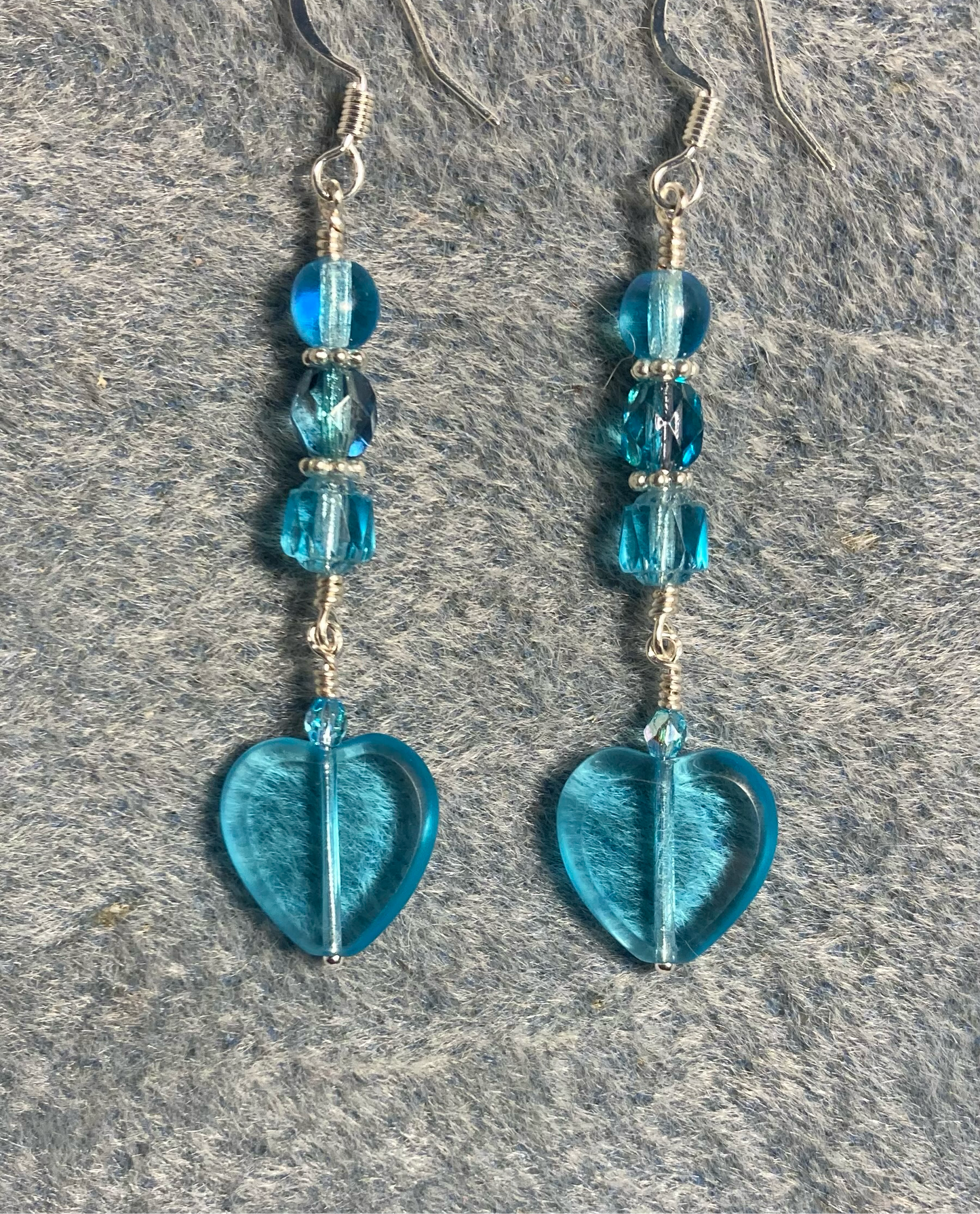 Translucent turquoise Czech glass heart bead earrings adorned with turquoise Czech glass beads.