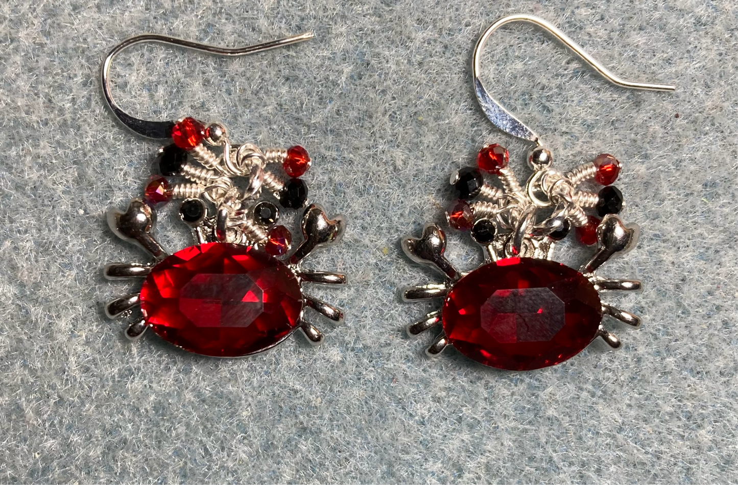 Silver and bright red rhinestone crab charm earrings adorned with tiny dangling red, silver, and black Chinese crystal beads.