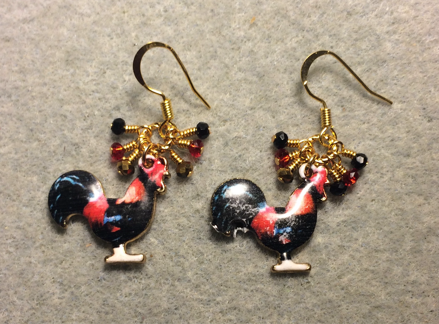 Black and red enamel rooster charm earrings adorned with tiny dangling black, red, and gold Chinese crystal beads.
