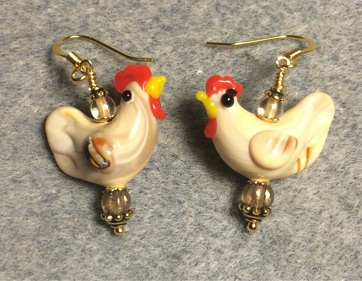 Light tan lamp work chicken bead earrings adorned with tan Czech glass beads.