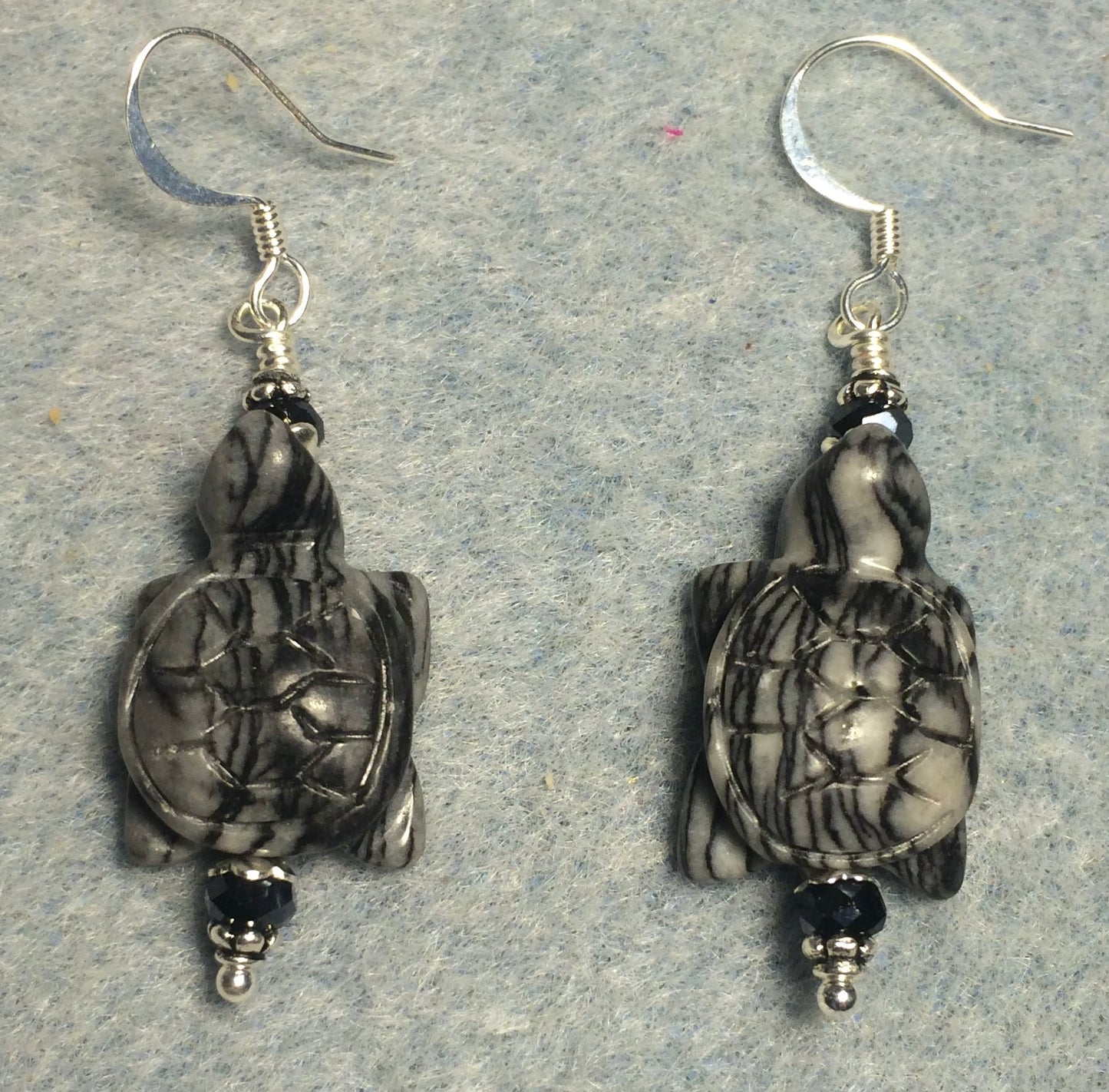 Gray black jasper gemstone turtle bead earrings adorned with black Chinese crystal beads.