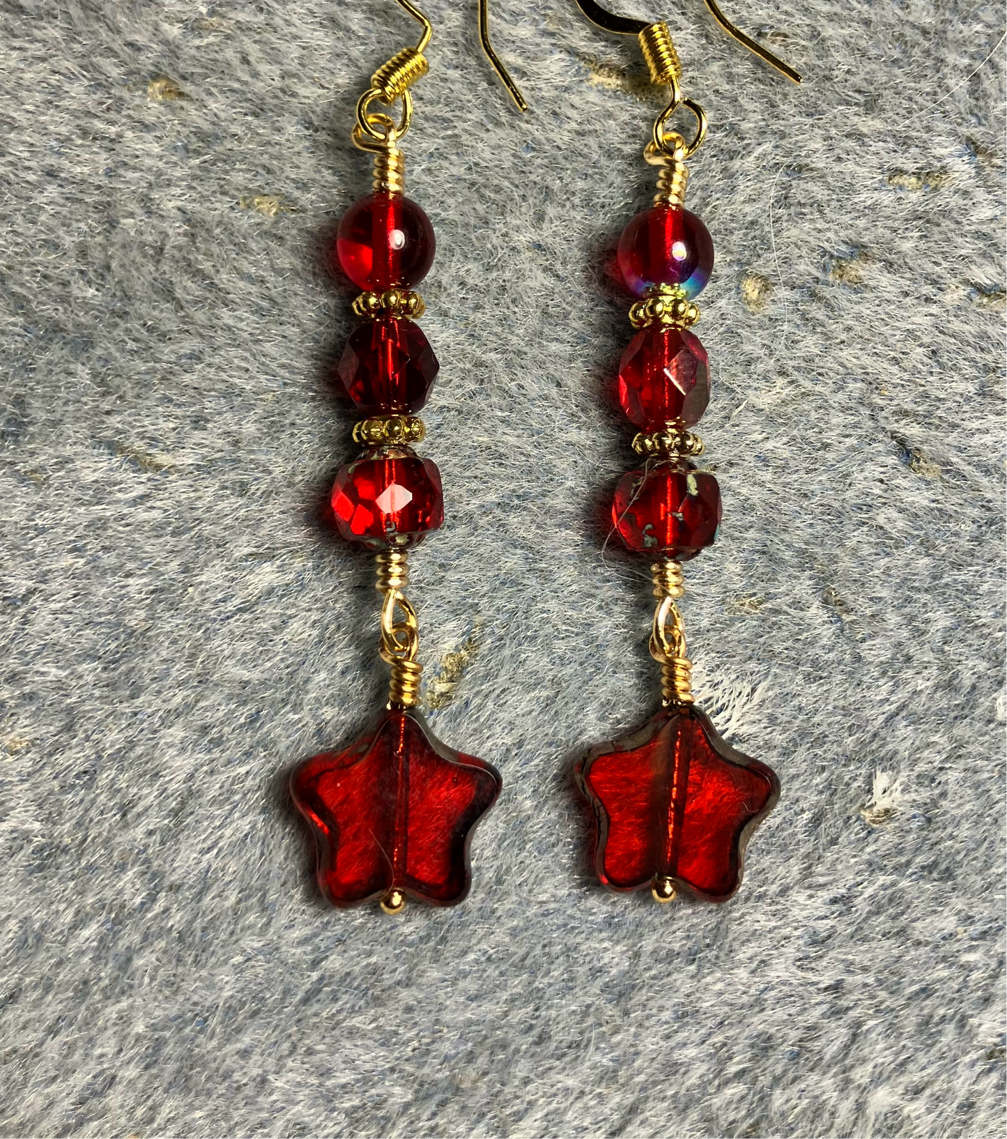 Small translucent red Czech glass star bead earrings adorned with bright red Czech glass beads.