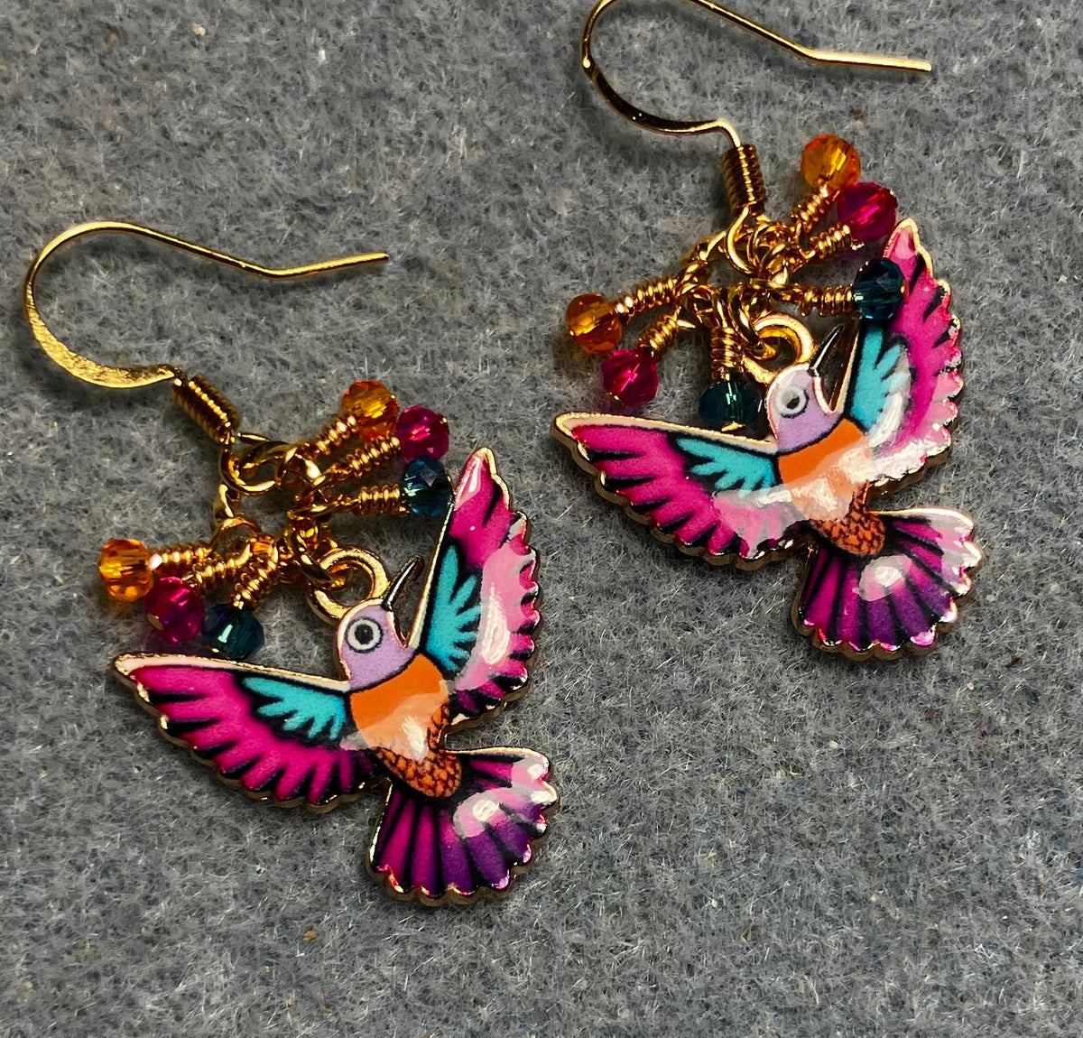 Hot pink, orange, and turquoise enamel hummingbird charm earrings adorned with tiny dangling hot pink, orange, and turquoise Chinese crystal beads.