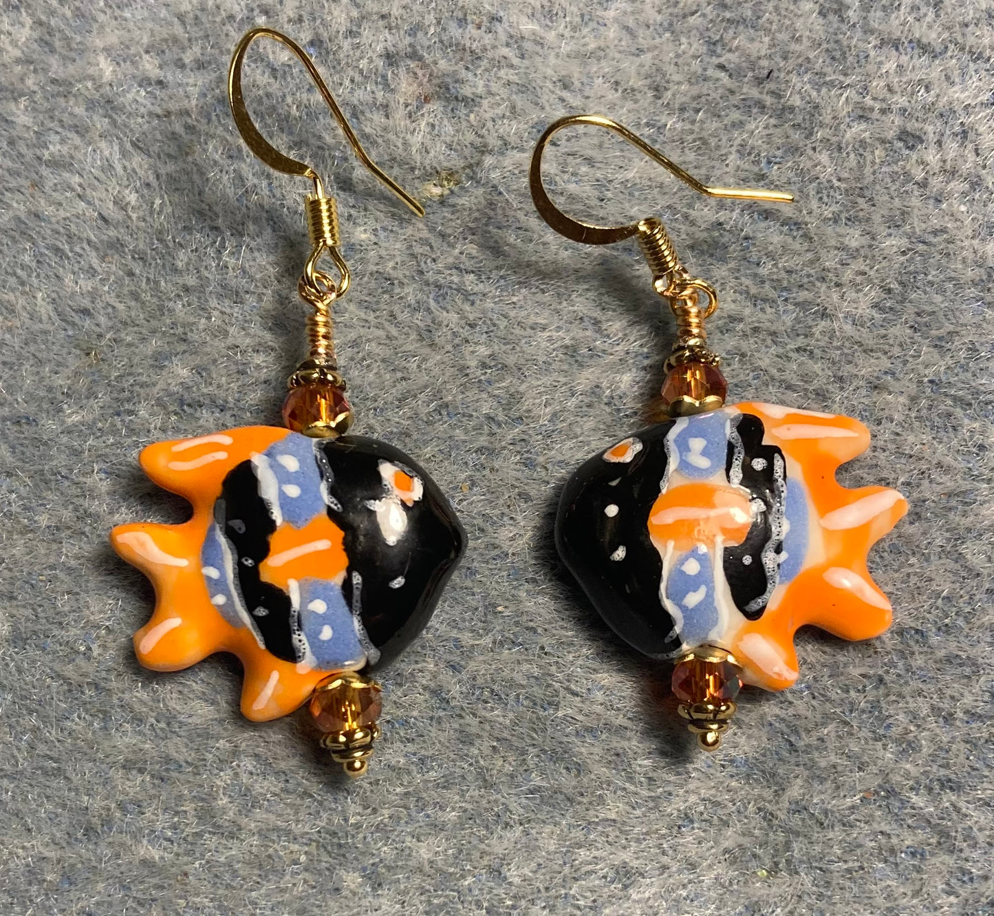 Black, orange, and blue ceramic angelfish bead earrings adorned with orange Chinese crystal beads.