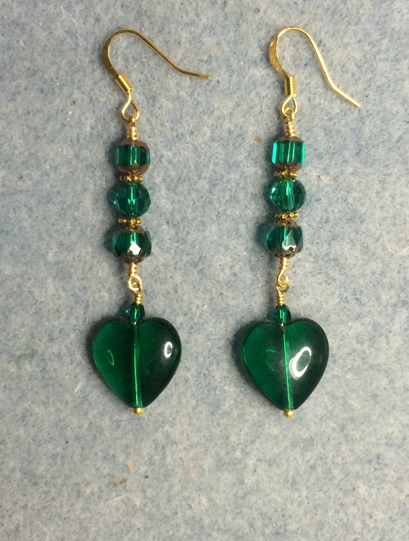 Emerald green Czech glass heart bead earrings adorned with emerald green Czech glass beads.