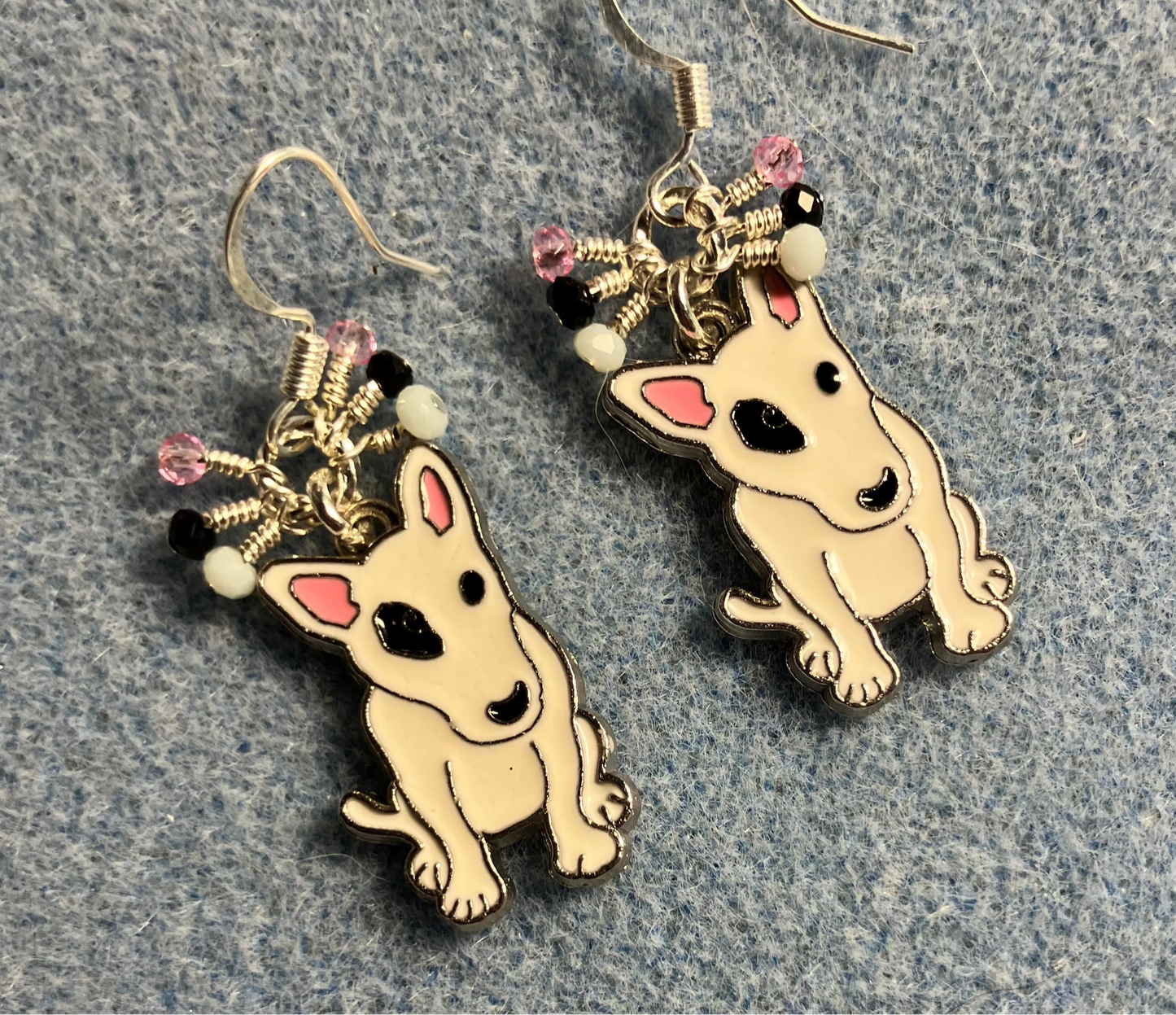 White, black, and pink enamel English bull terrier charm earrings adorned with tiny dangling white, black, and pink Chinese crystal beads.