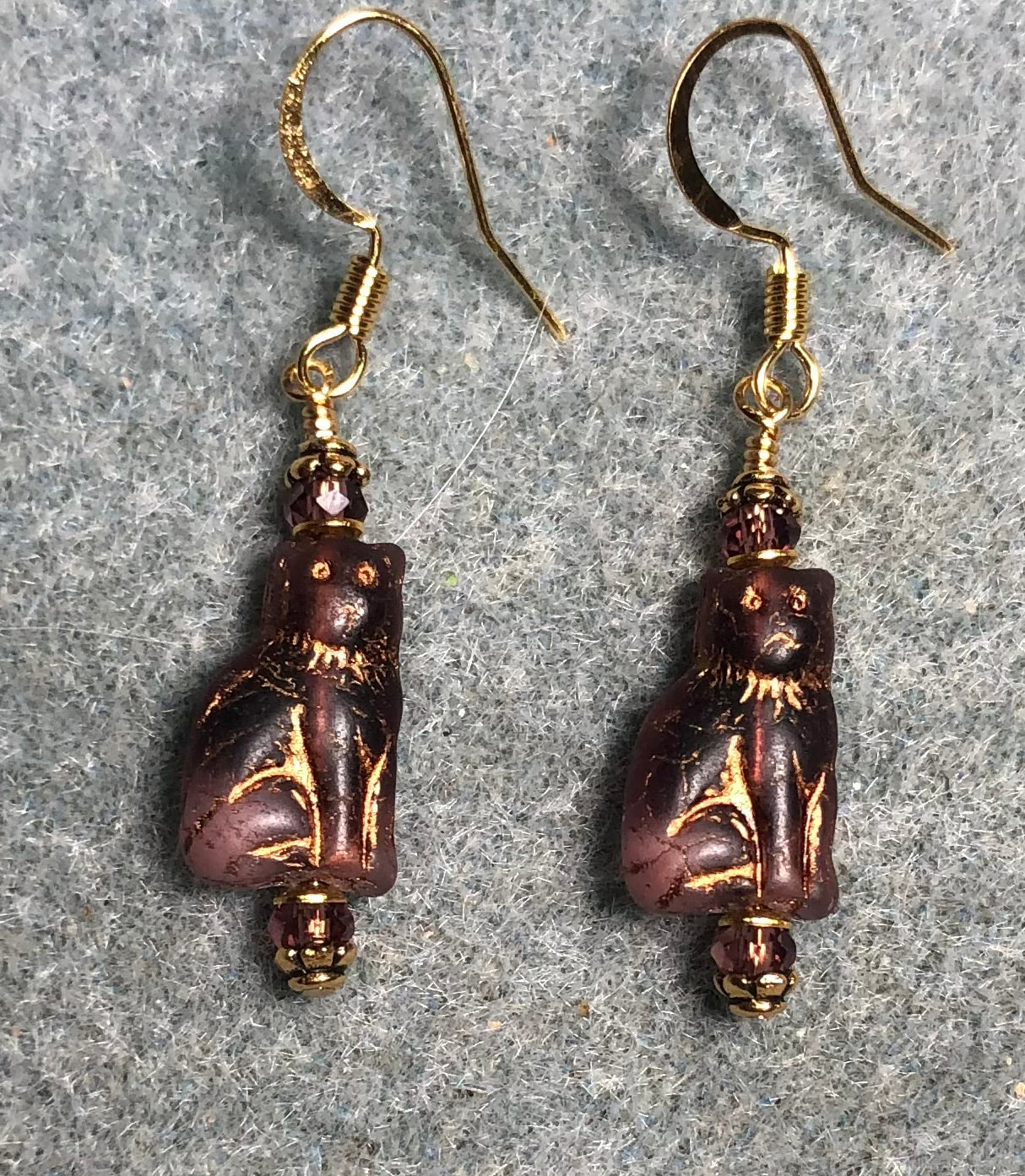 Small purple and gold Czech glass cat bead earrings adorned with purple Chinese crystal beads.