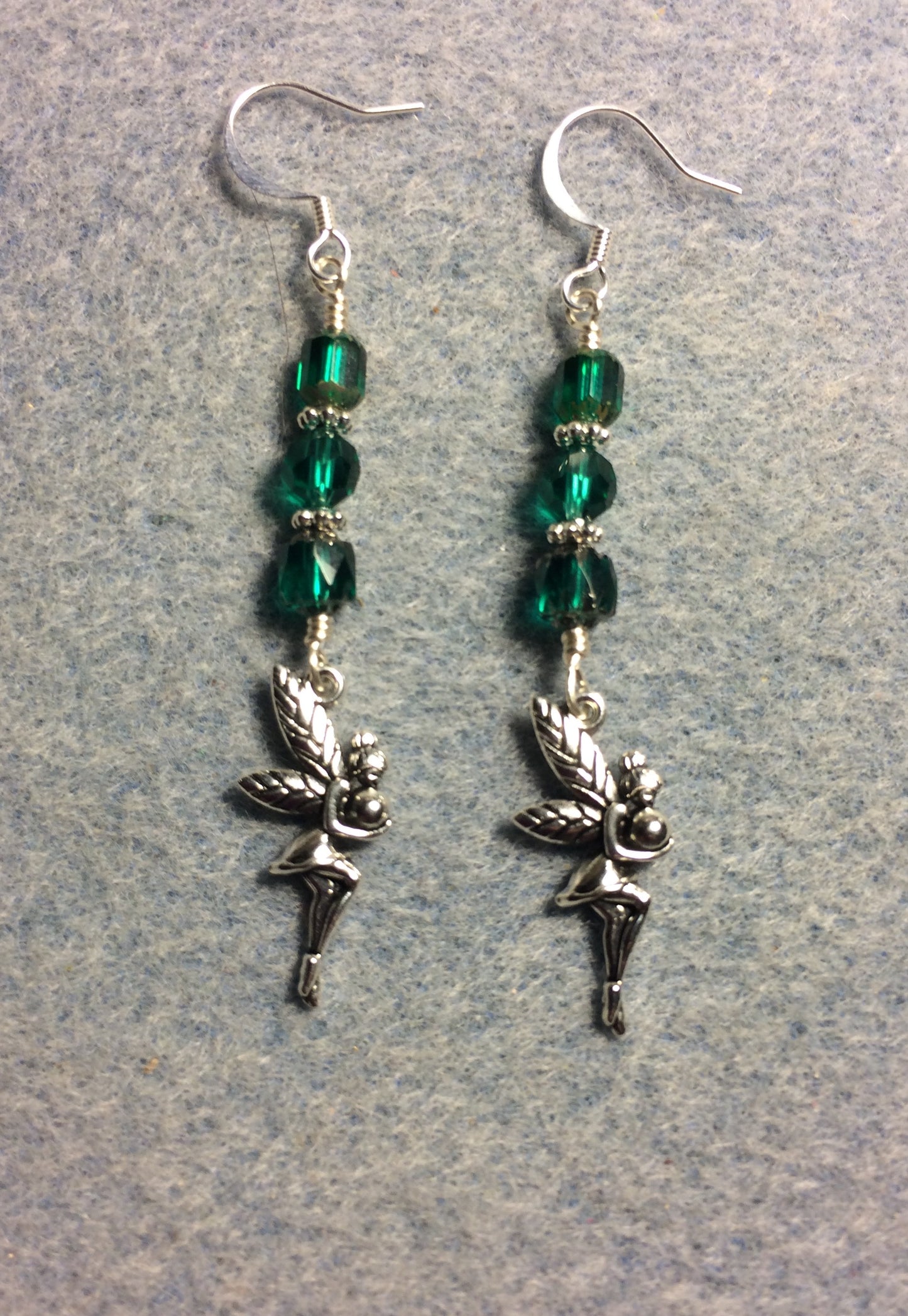 Silver fairy charm earrings adorned with teal Czech glass beads.
