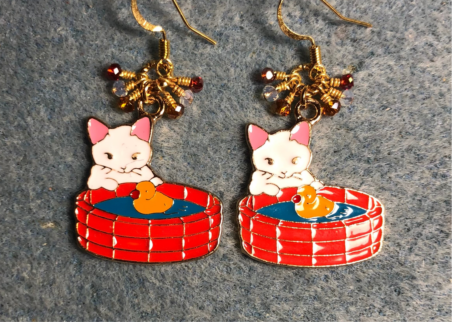 White, pink, red, and amber enamel cat charm earrings adorned with tiny dangling white, red, and amber Chinese crystal beads.