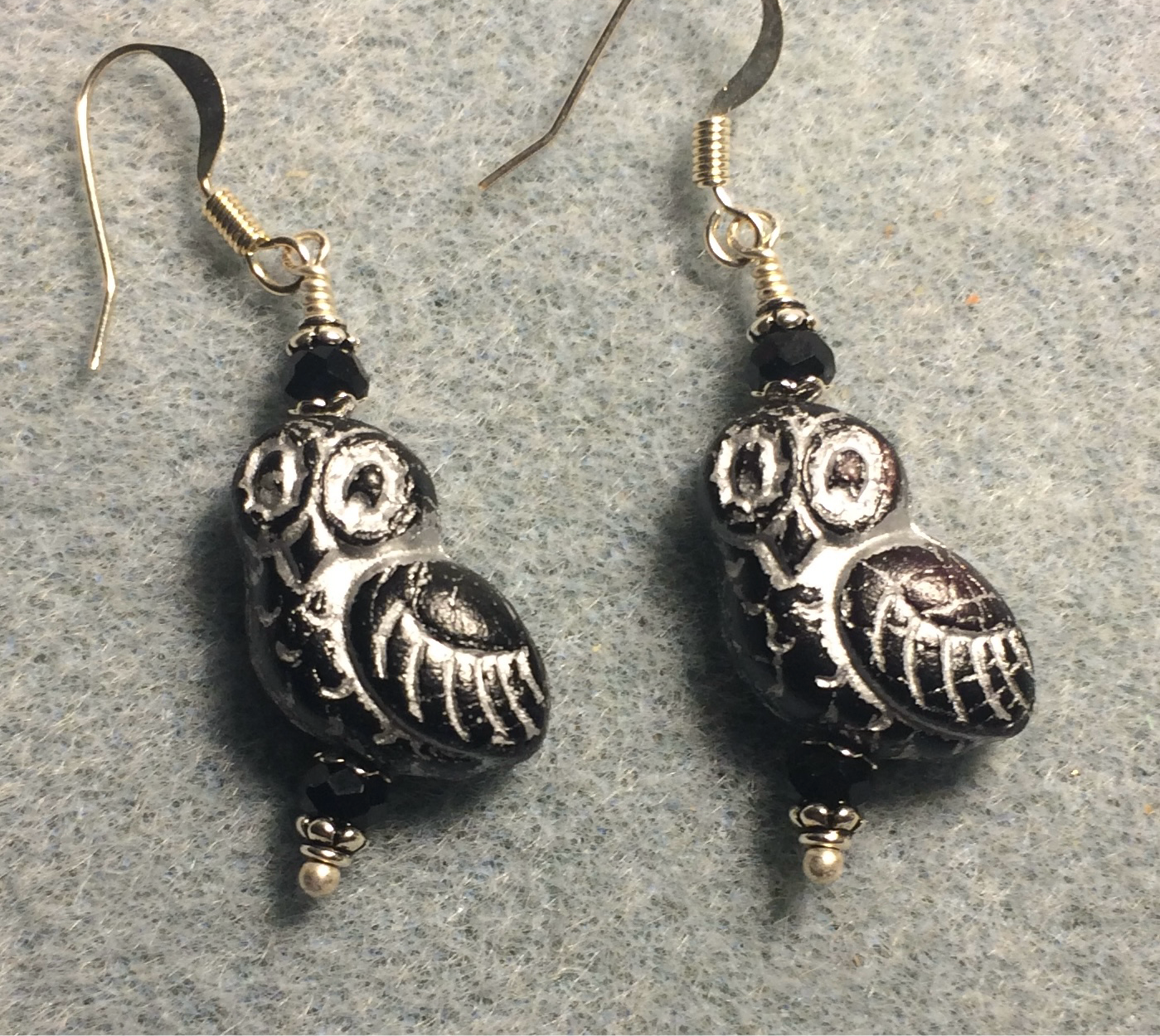 Black (with silver wash) fancy Czech glass owl bead earrings adorned with black Chinese crystal beads.