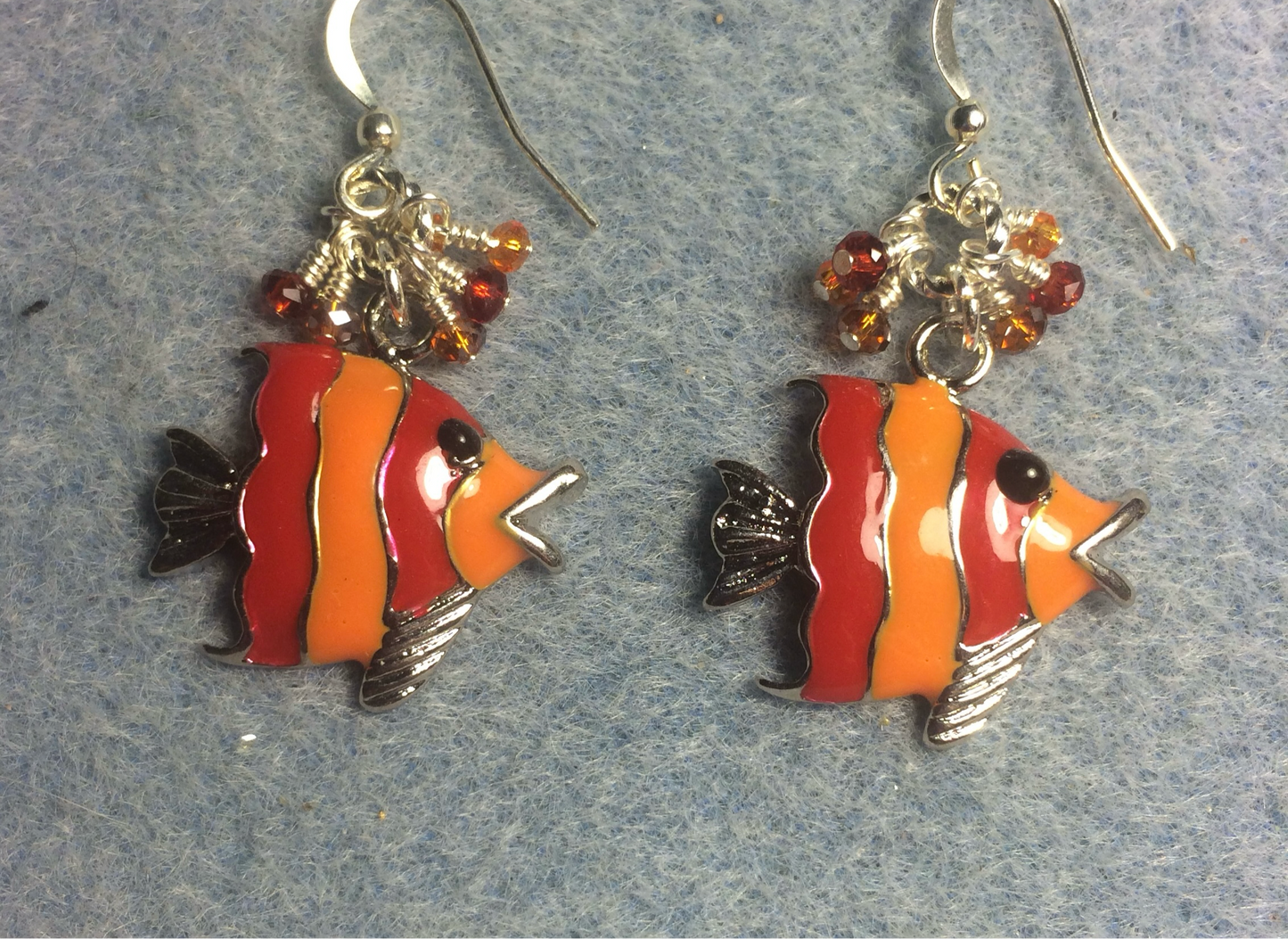 Red and orange enamel striped angelfish charm earrings adorned with tiny dangling red and orange Chinese crystal beads.