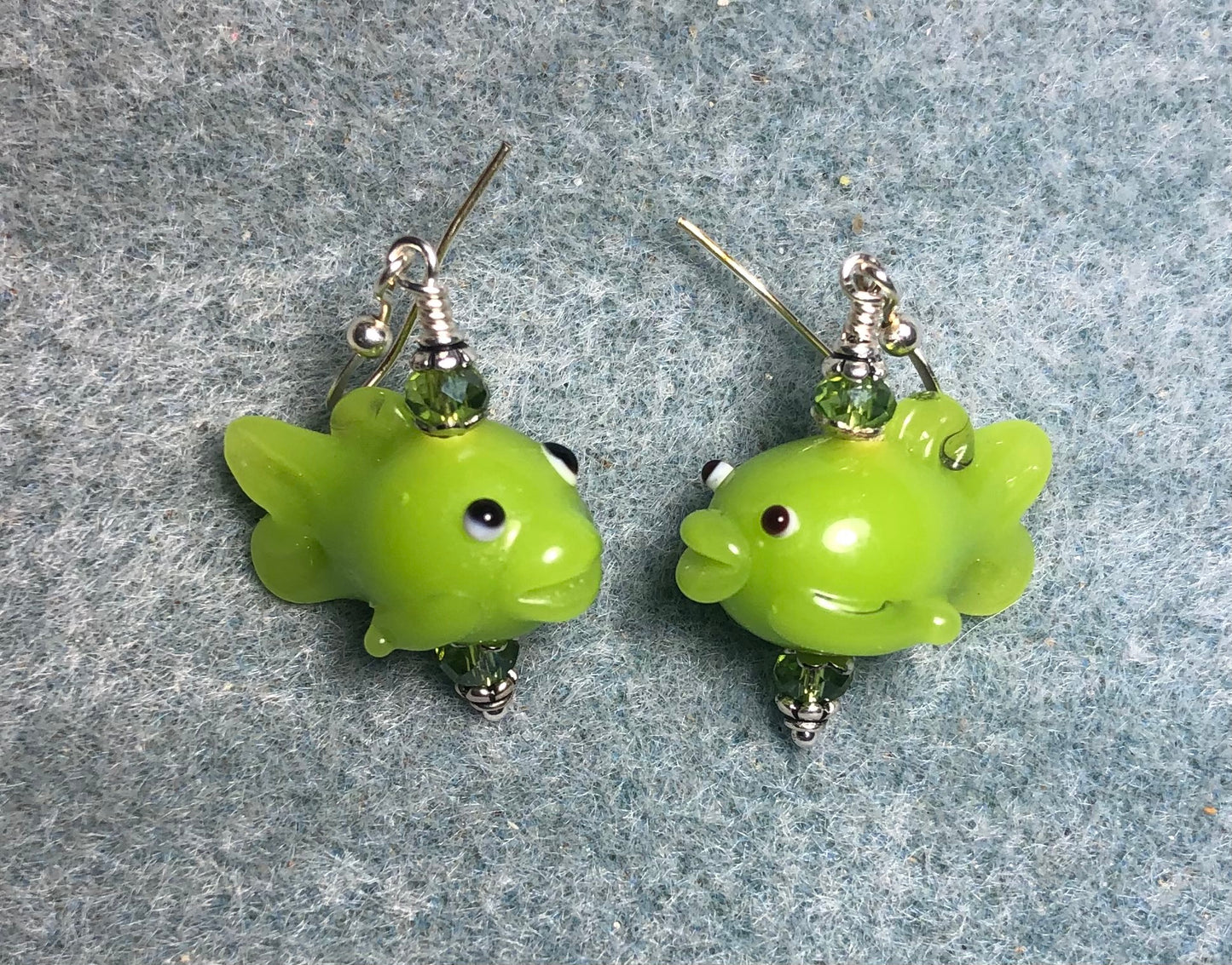 Green lamp work fish bead earrings adorned with green Chinese crystal beads.