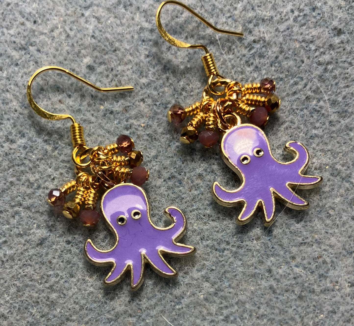 Violet and gold enamel octopus charm earrings adorned with tiny dangling violet and gold Chinese crystal beads.