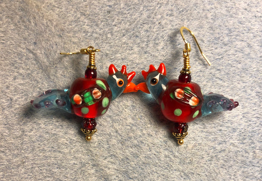 Translucent dark red and blue polka dotted lamp work chicken bead earrings adorned with dark red Czech glass beads.