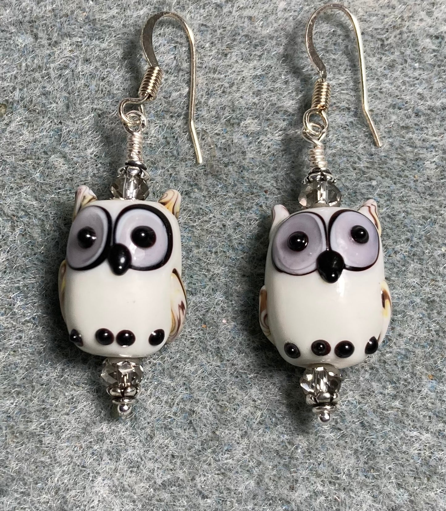 White and gray lamp work owl bead earrings adorned with gray Chinese crystal beads.