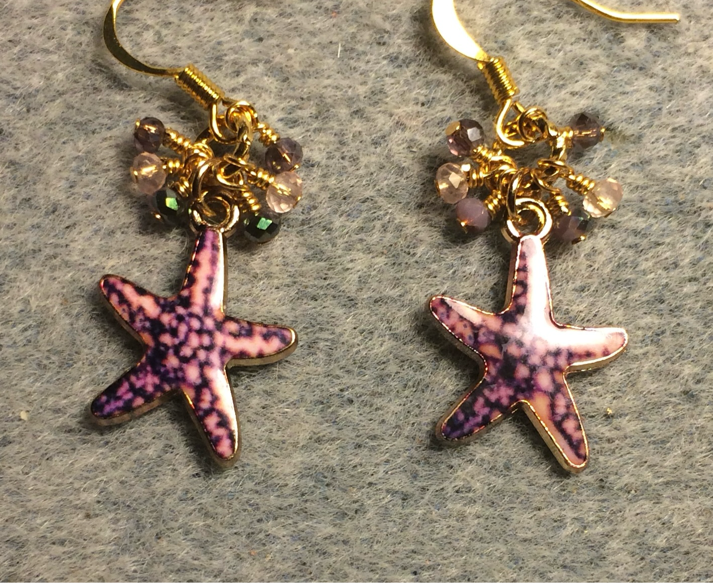 Purple and pink enamel starfish charm earrings adorned with tiny dangling purple and pink Chinese crystal beads.