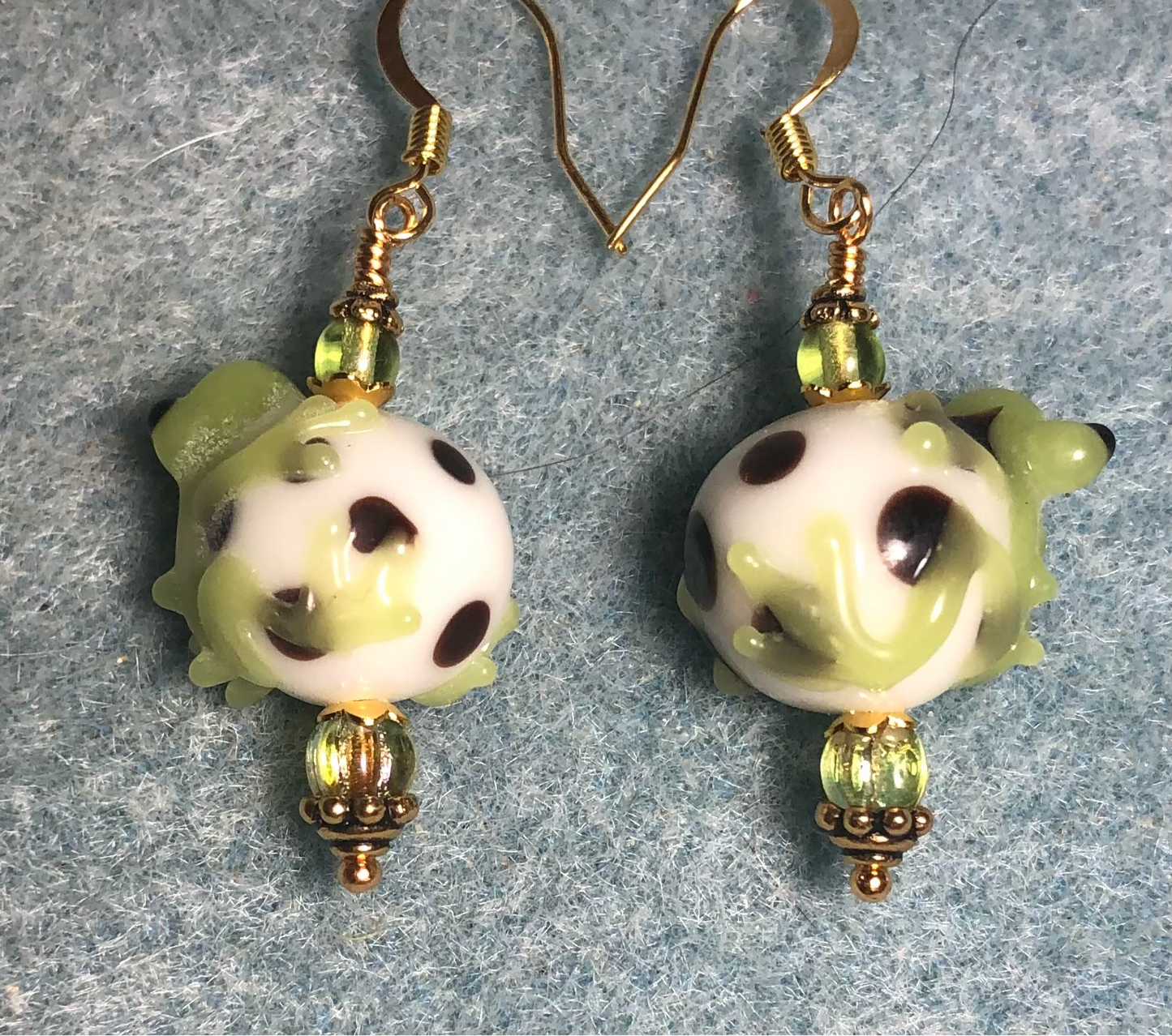 Lime green and white lamp work frog bead earrings adorned with lime green Czech glass beads.