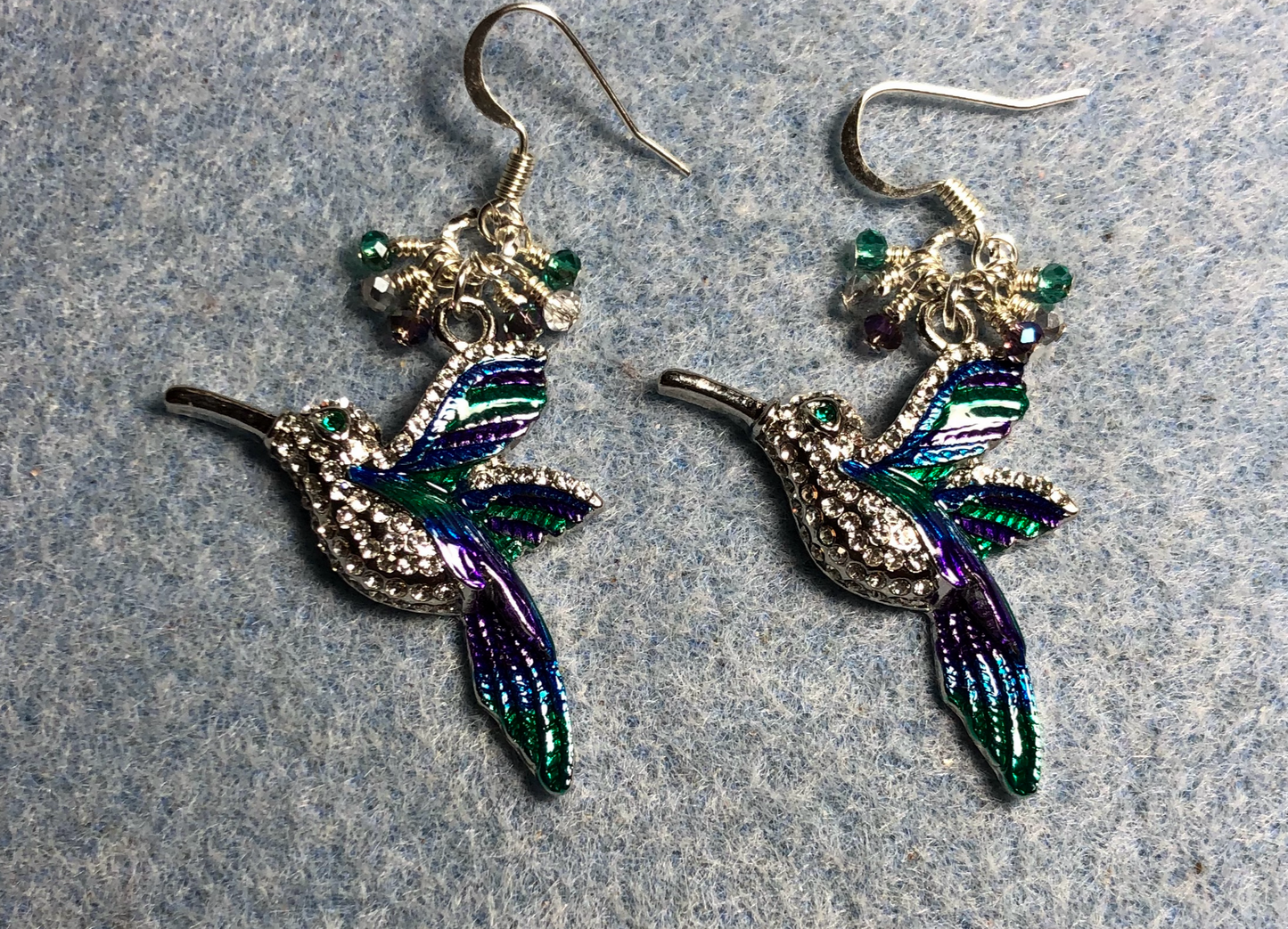 Silver, purple, and teal rhinestone hummingbird charm earrings adorned with tiny dangling purple, silver, and teal Chinese crystal beads.
