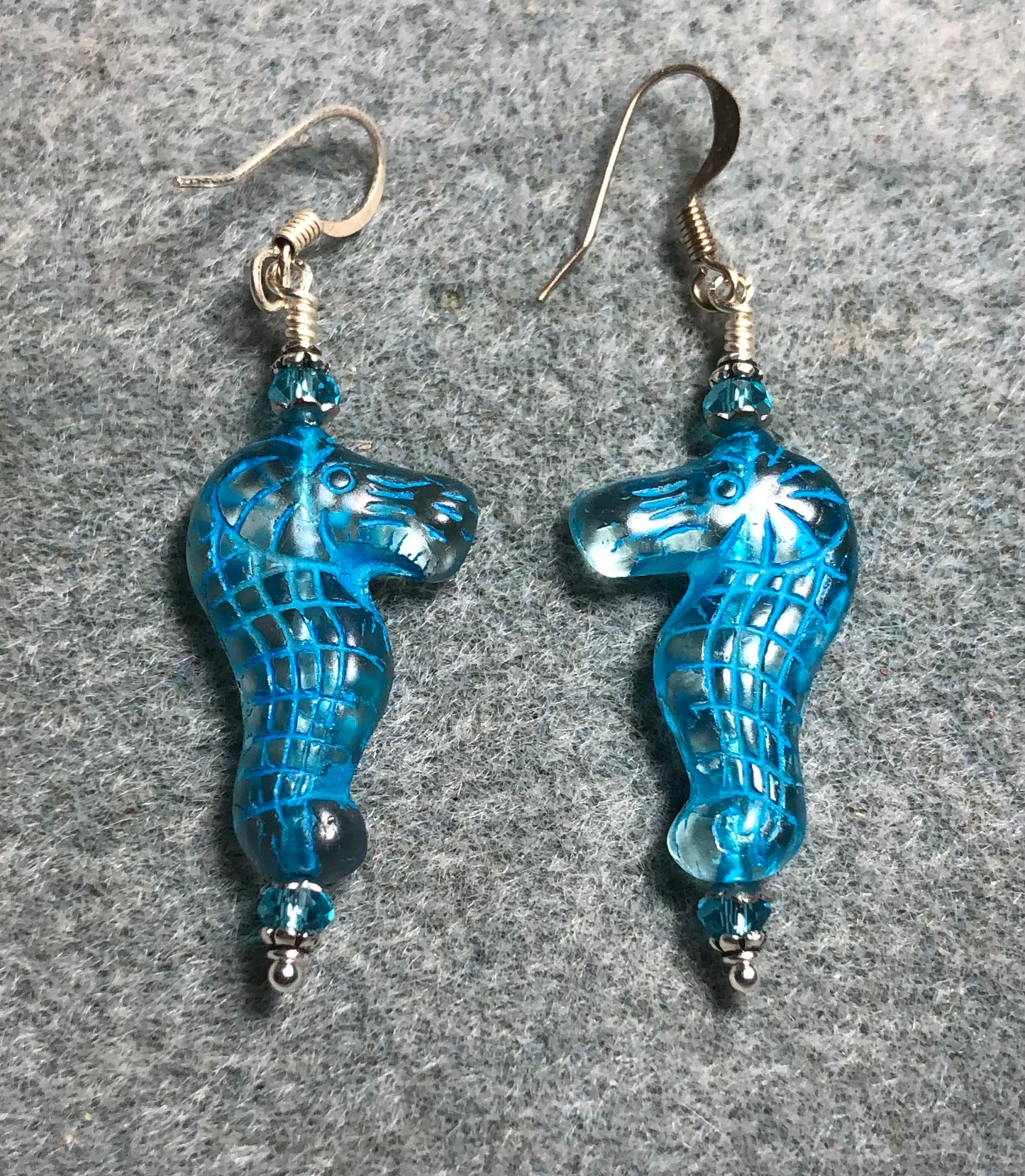 Clear (with turquoise inlay) Czech glass seahorse bead earrings adorned with turquoise Chinese crystal beads.