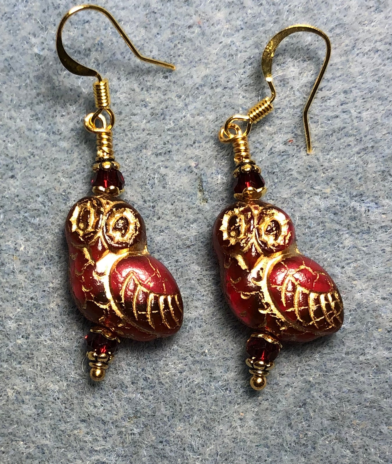 Dark red (with gold wash) fancy Czech glass owl bead earrings adorned with dark red Chinese crystal beads.