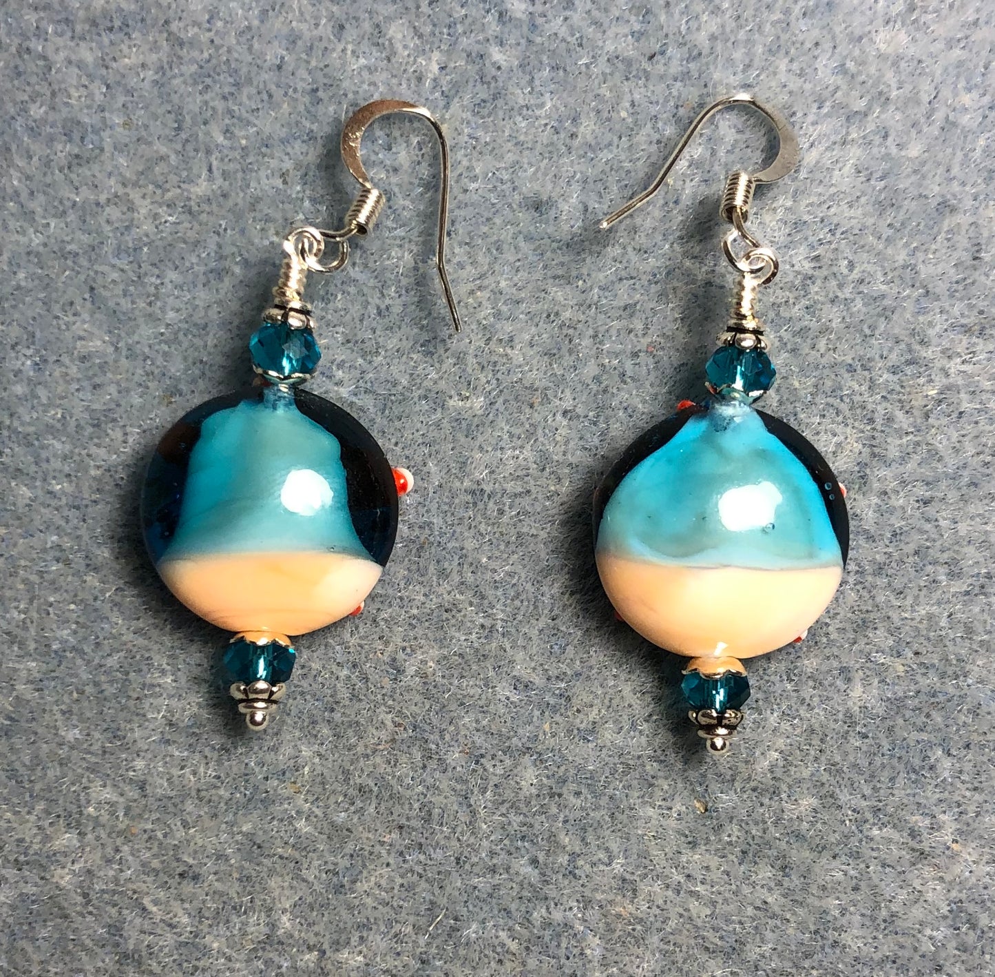 Turquoise, red, and tan lamp work starfish bead earrings adorned with turquoise Chinese crystal beads.