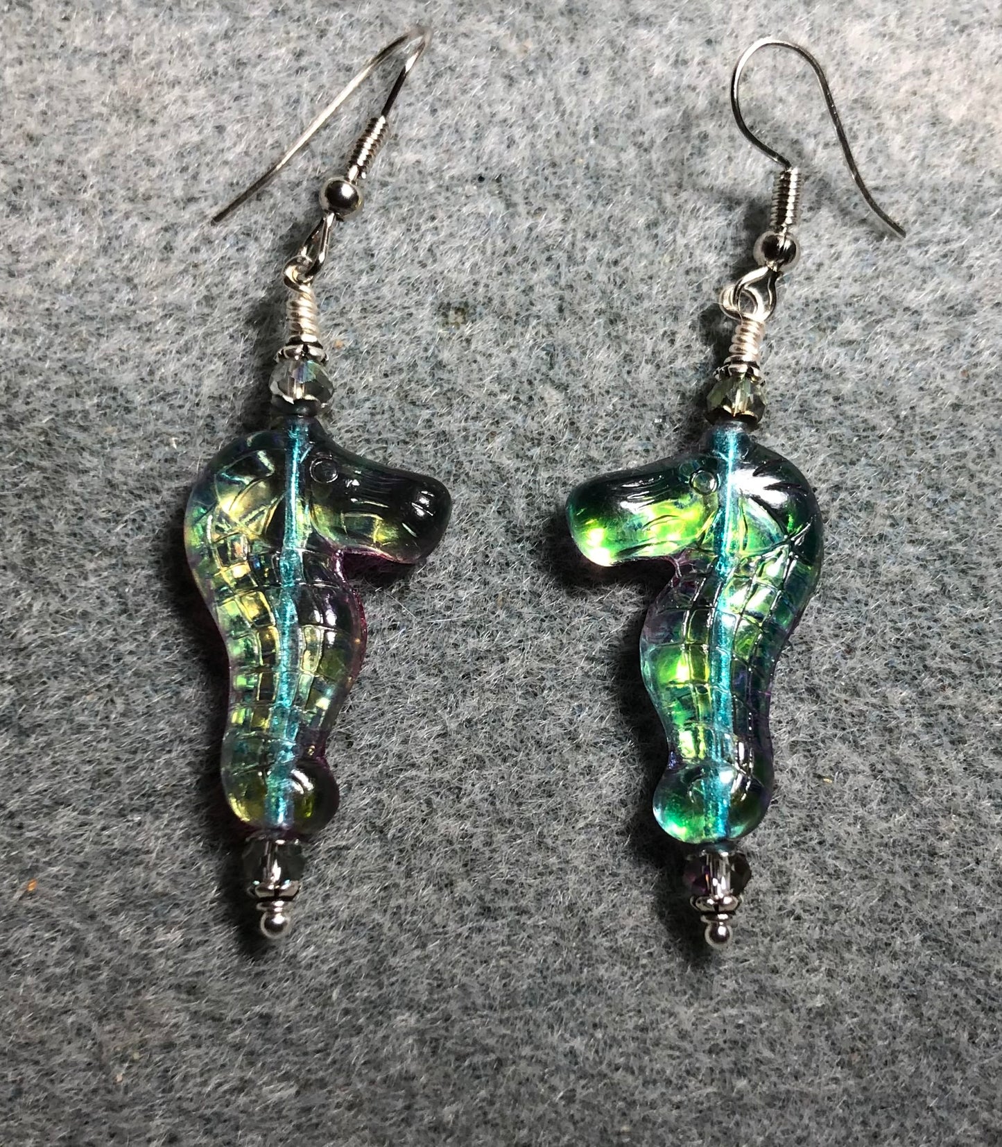 Shimmery blue green Czech glass seahorse bead earrings adorned with sparkly blue green Chinese crystal beads.
