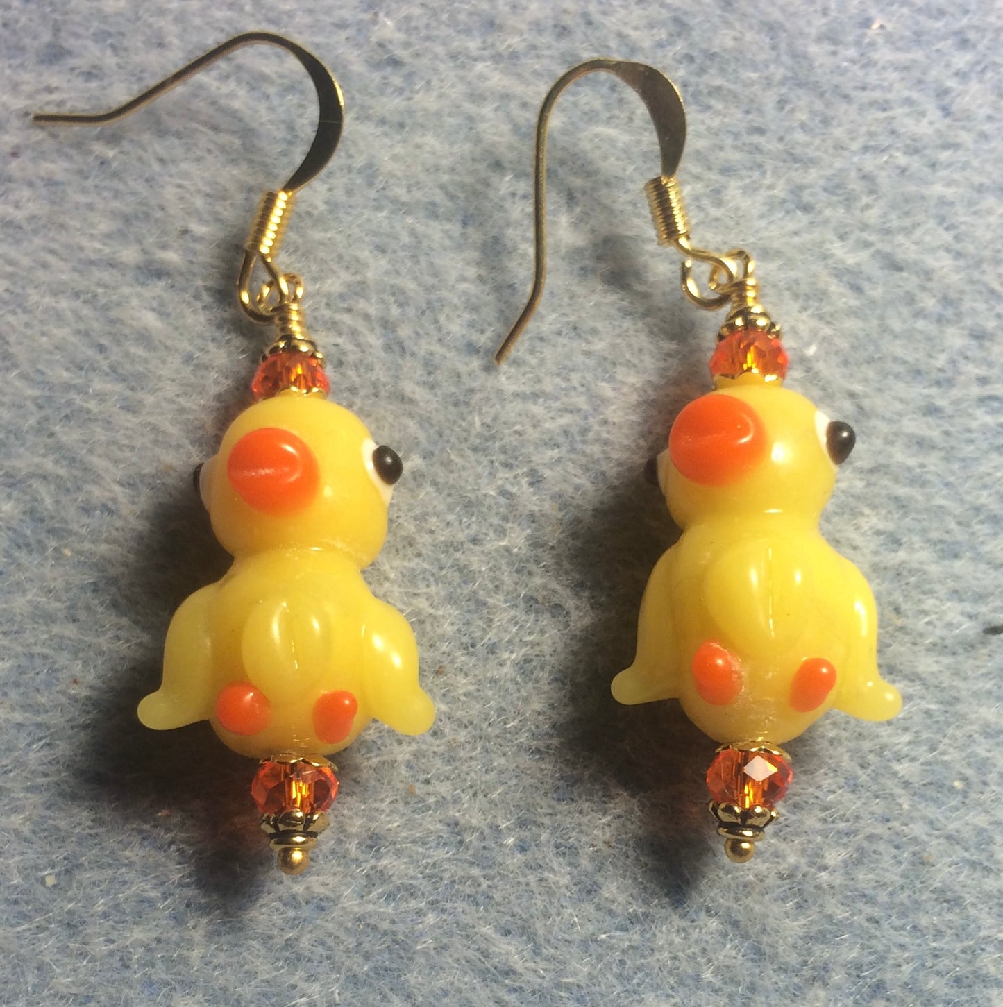 Yellow and orange lamp work duck bead earrings adorned with orange Chinese crystal beads.