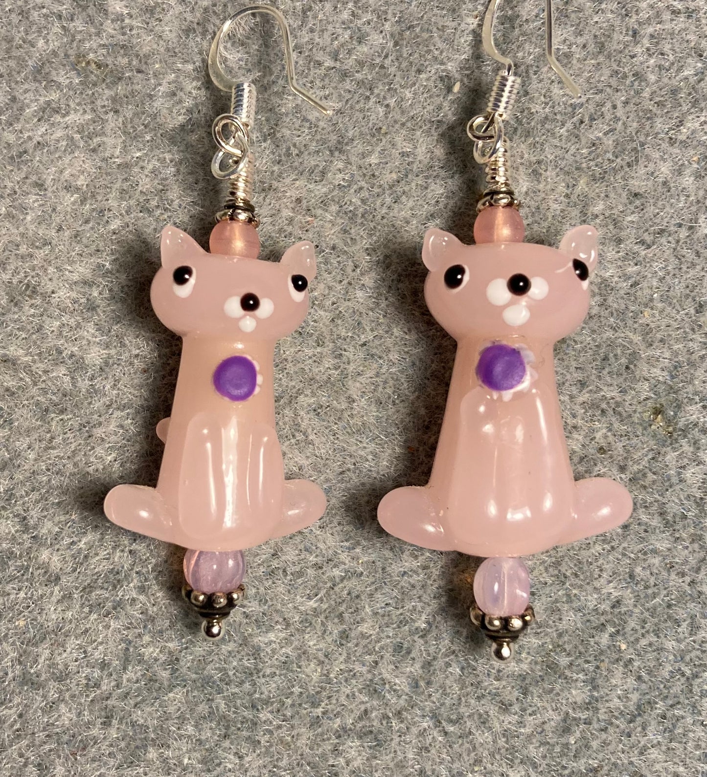 Pink lamp work cat bead earrings adorned with pink Czech glass beads.