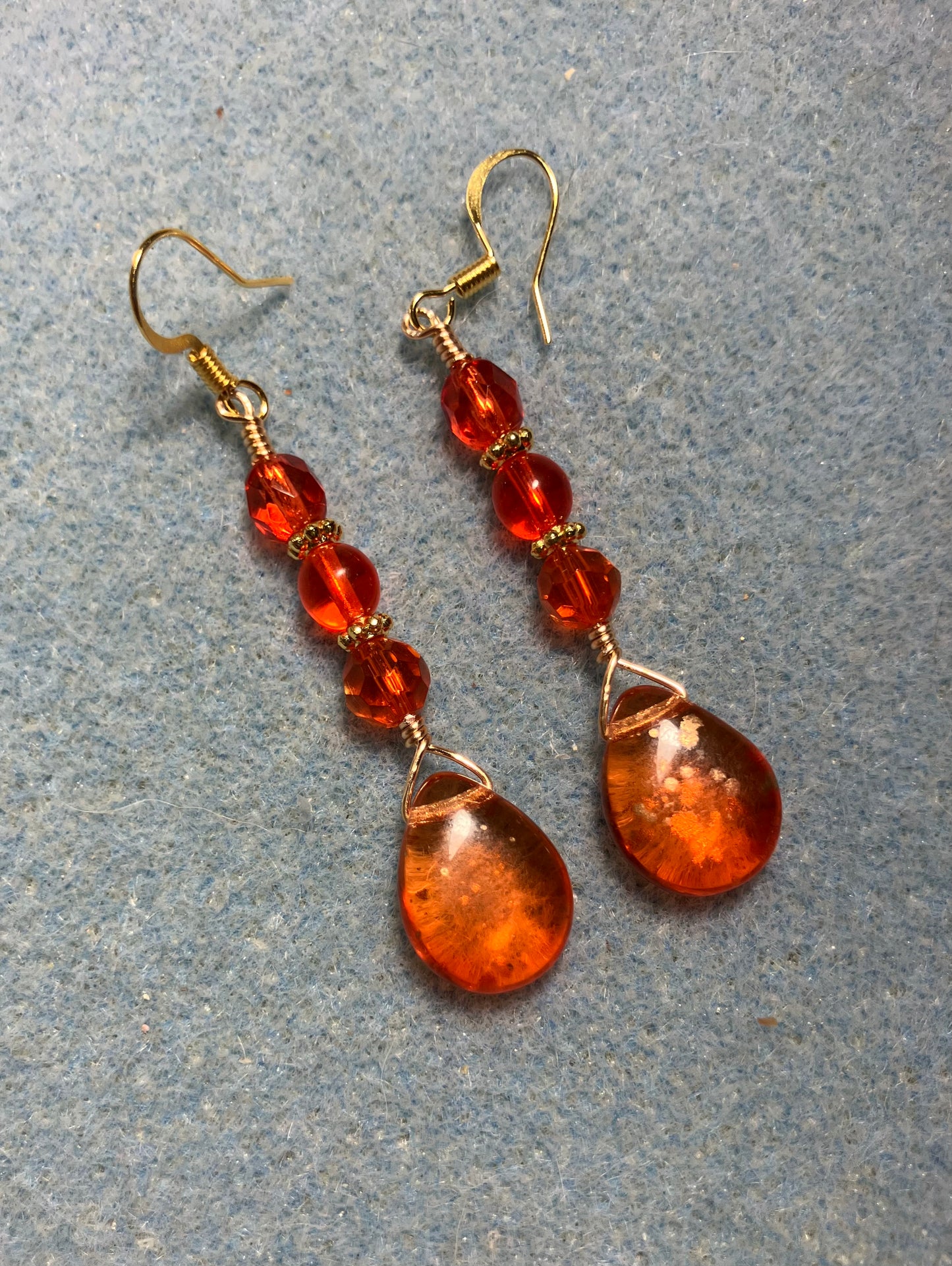 Orange gold dust Czech glass pear drop bead earrings adorned with orange Czech glass beads.