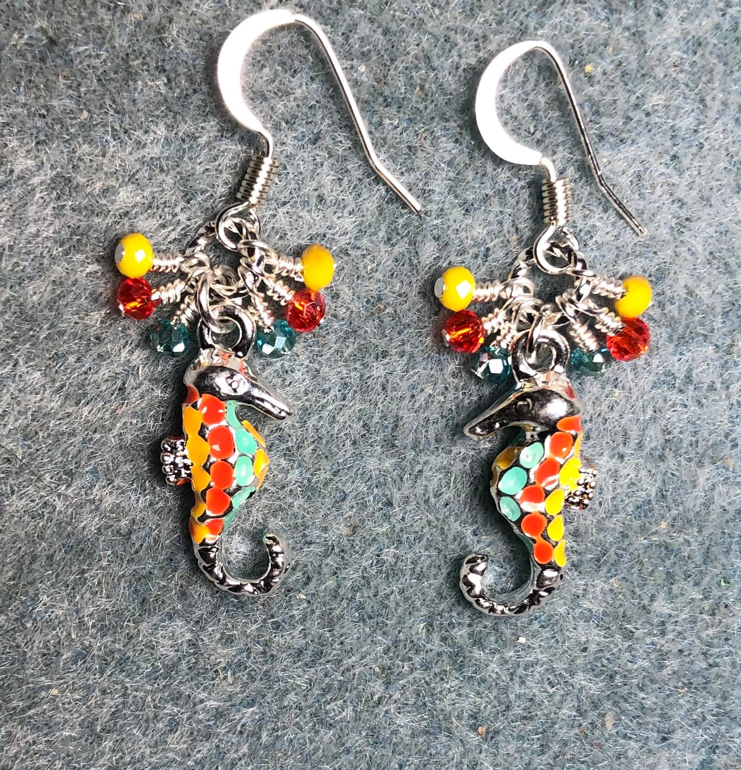 Silver, yellow, orange, and aqua enamel seahorse charm earrings adorned with tiny dangling yellow, orange, and aqua Chinese crystal beads.