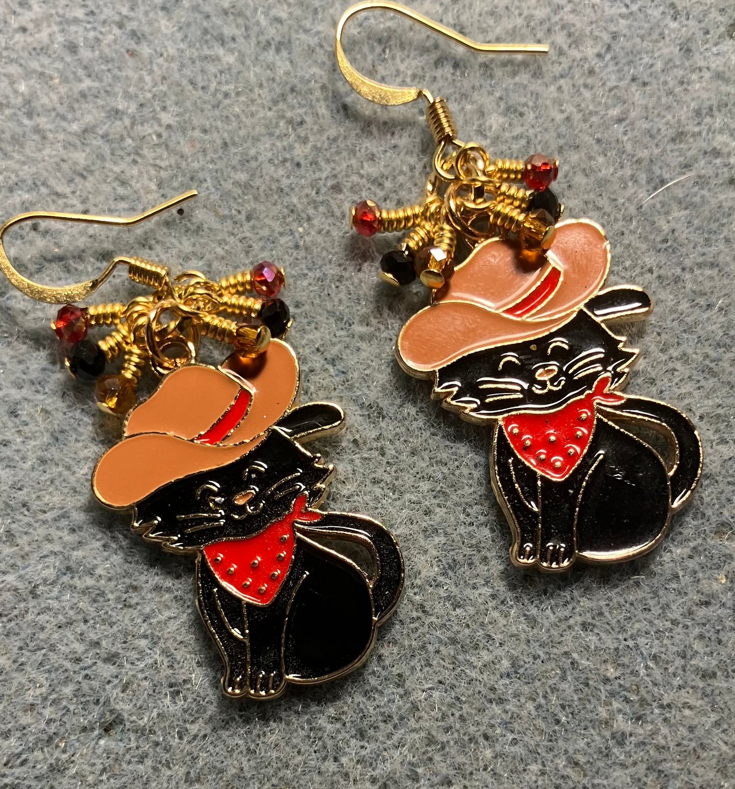 Black, brown, and red enamel cowboy cat charm earrings adorned with tiny dangling black, brown, and red Chinese crystal beads.