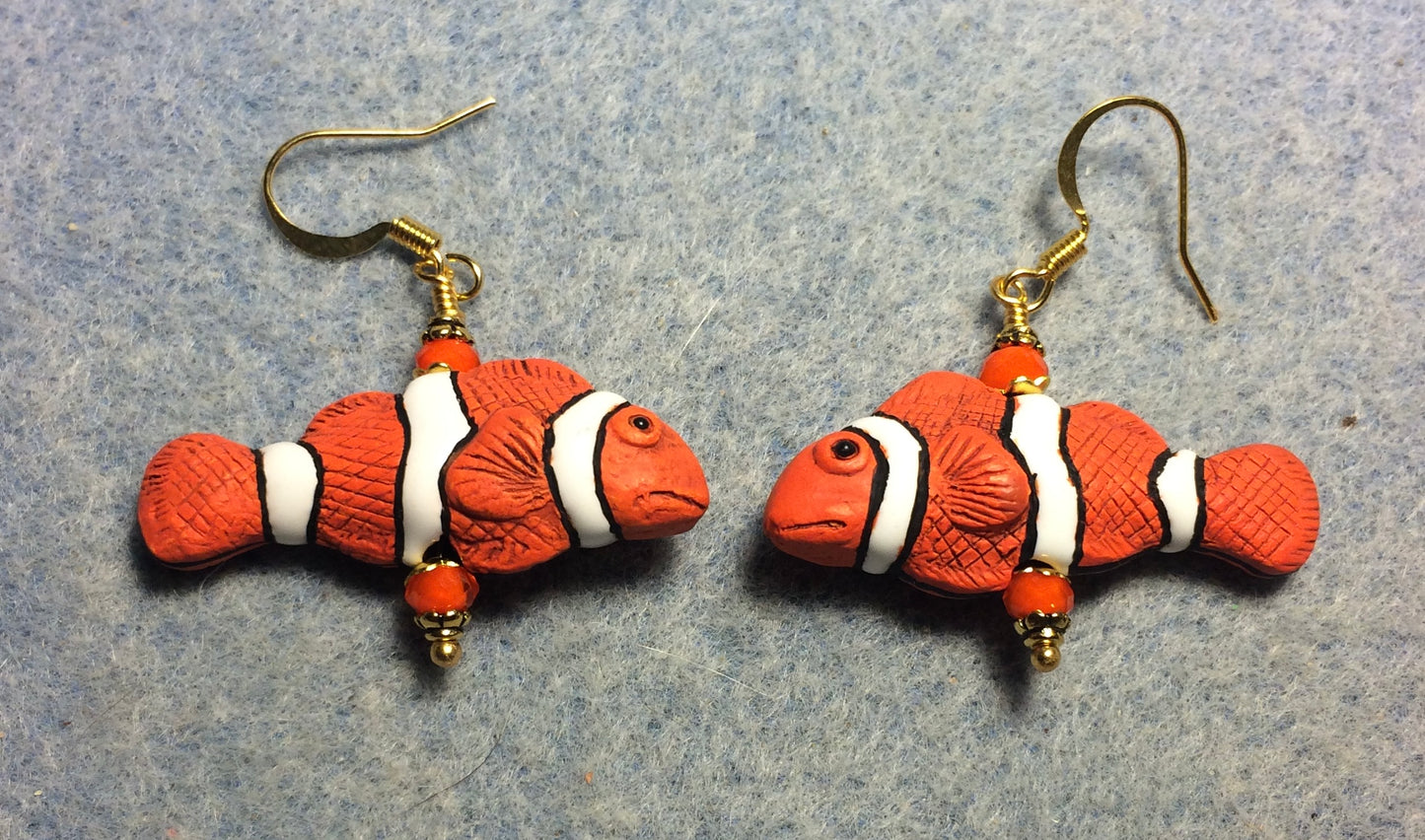 Orange, black, and white ceramic striped clownfish bead earrings adorned with orange Chinese crystal beads.
