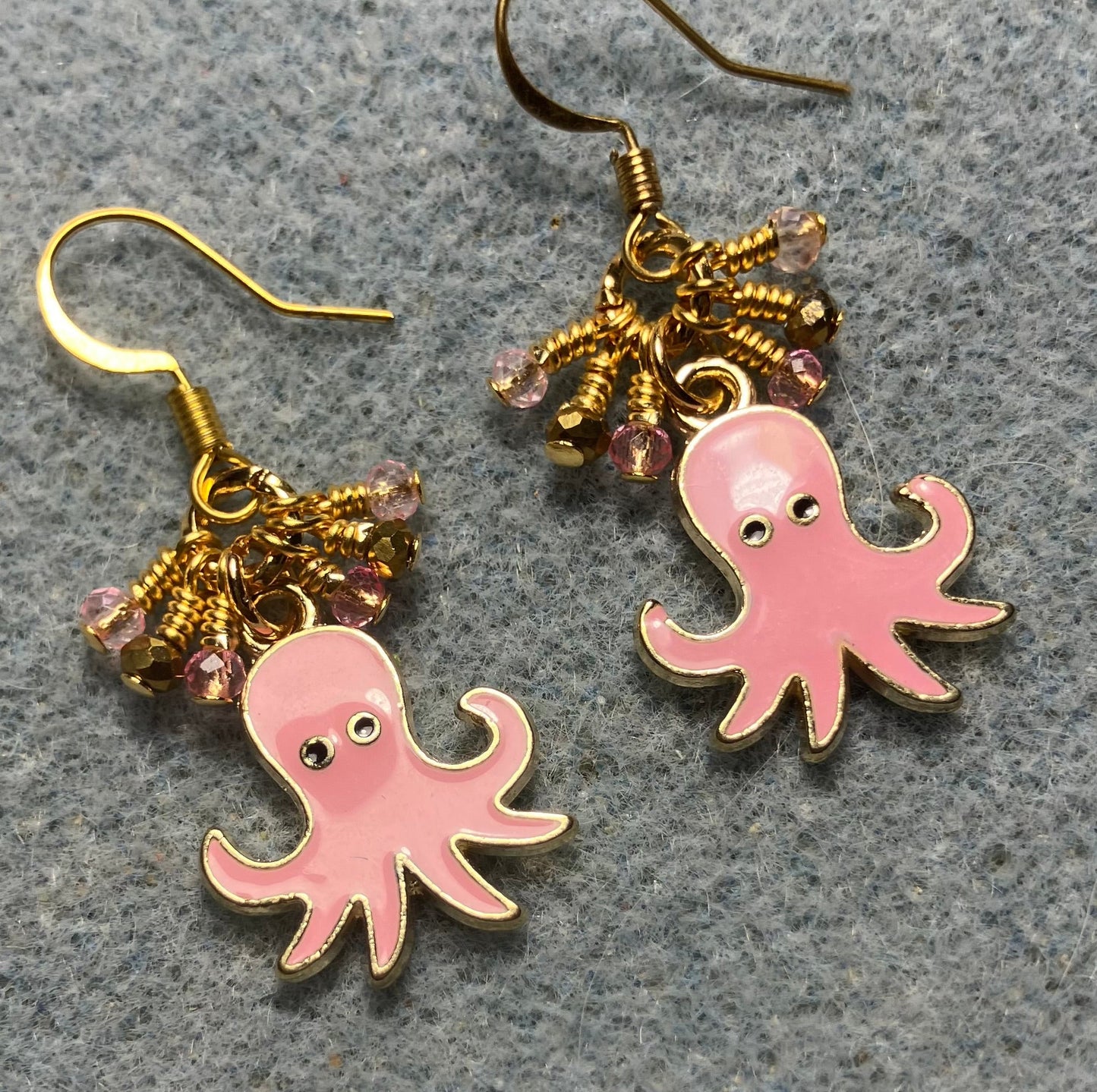Pink and gold enamel octopus charm earrings adorned with tiny dangling pink and gold Chinese crystal beads.