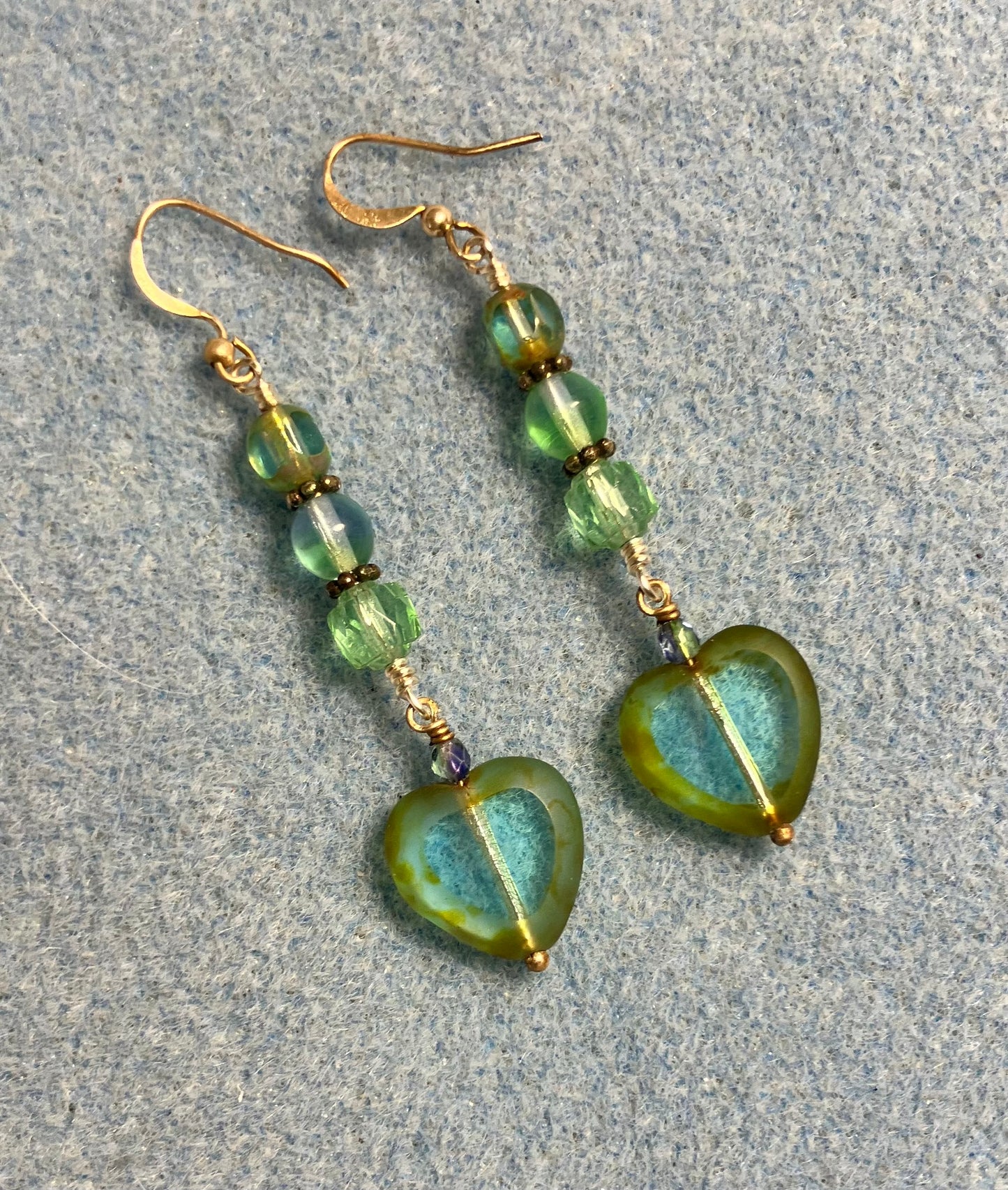 Light blue green Czech glass heart bead earrings adorned with blue green Czech glass beads.