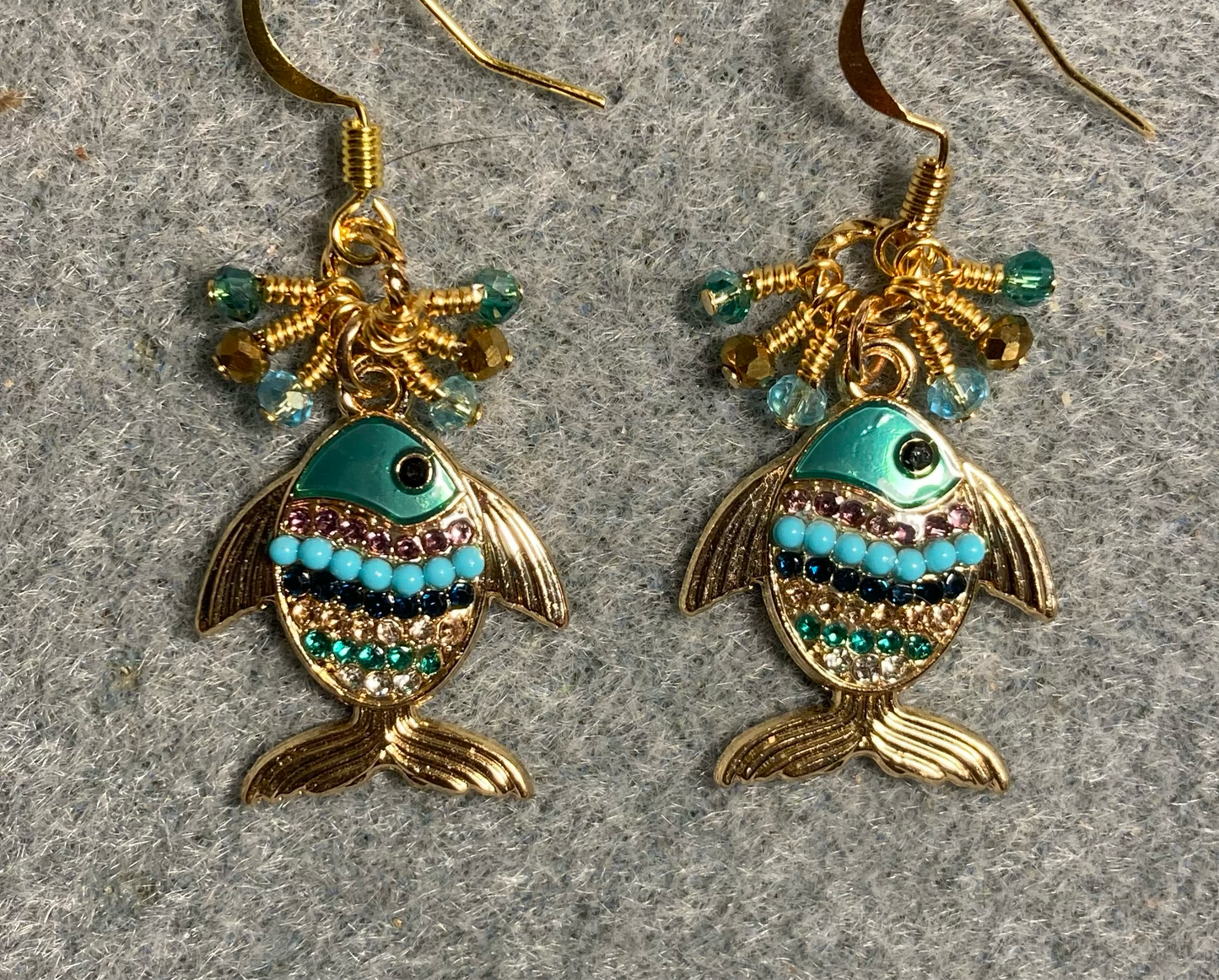 Gold, turquoise, and teal enamel fish charm earrings adorned with tiny dangling gold, turquoise, and teal Chinese crystal beads.