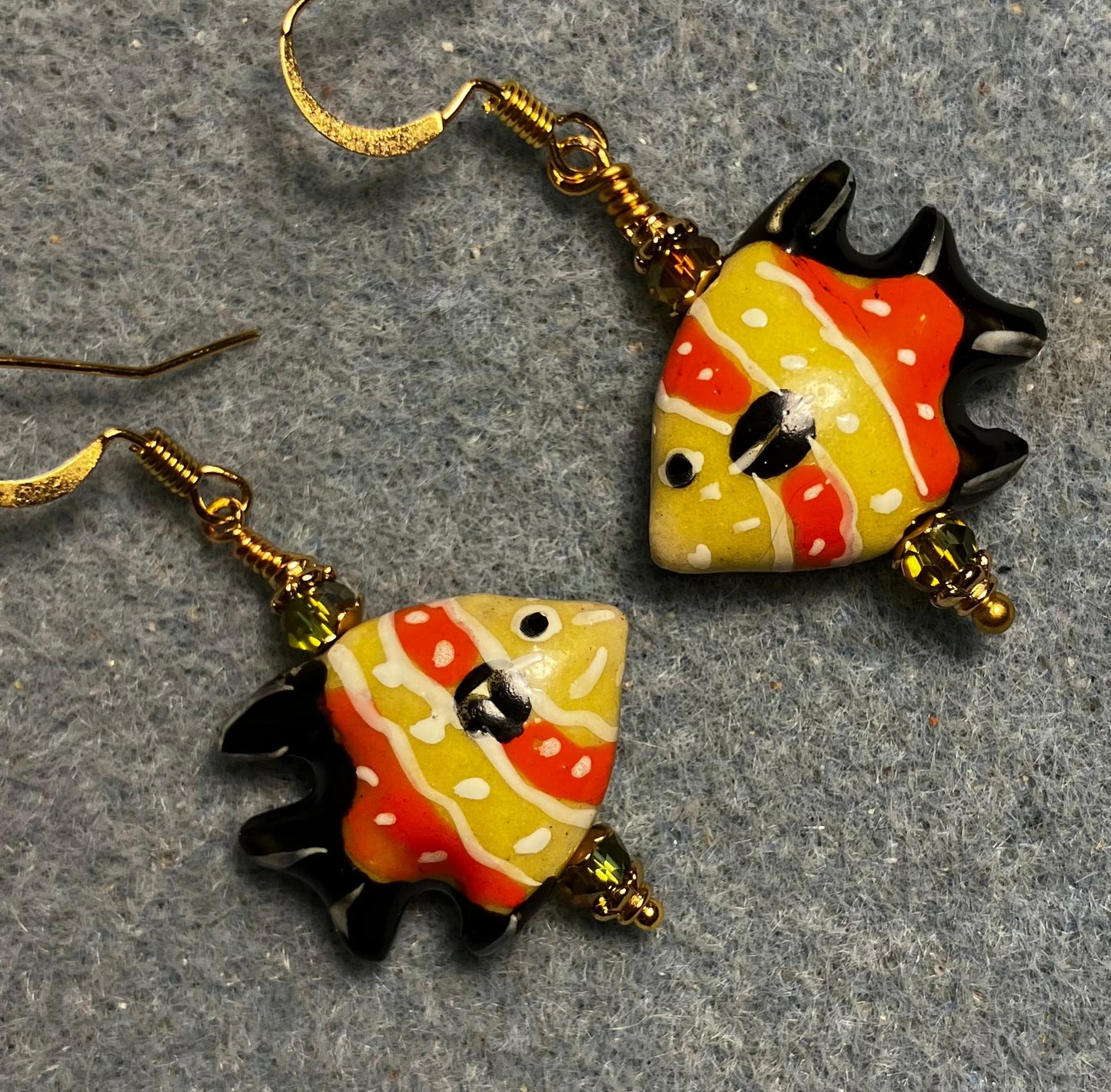 Orange, olive green, and black ceramic angelfish bead earrings adorned with sparkly olive green Chinese crystal beads.