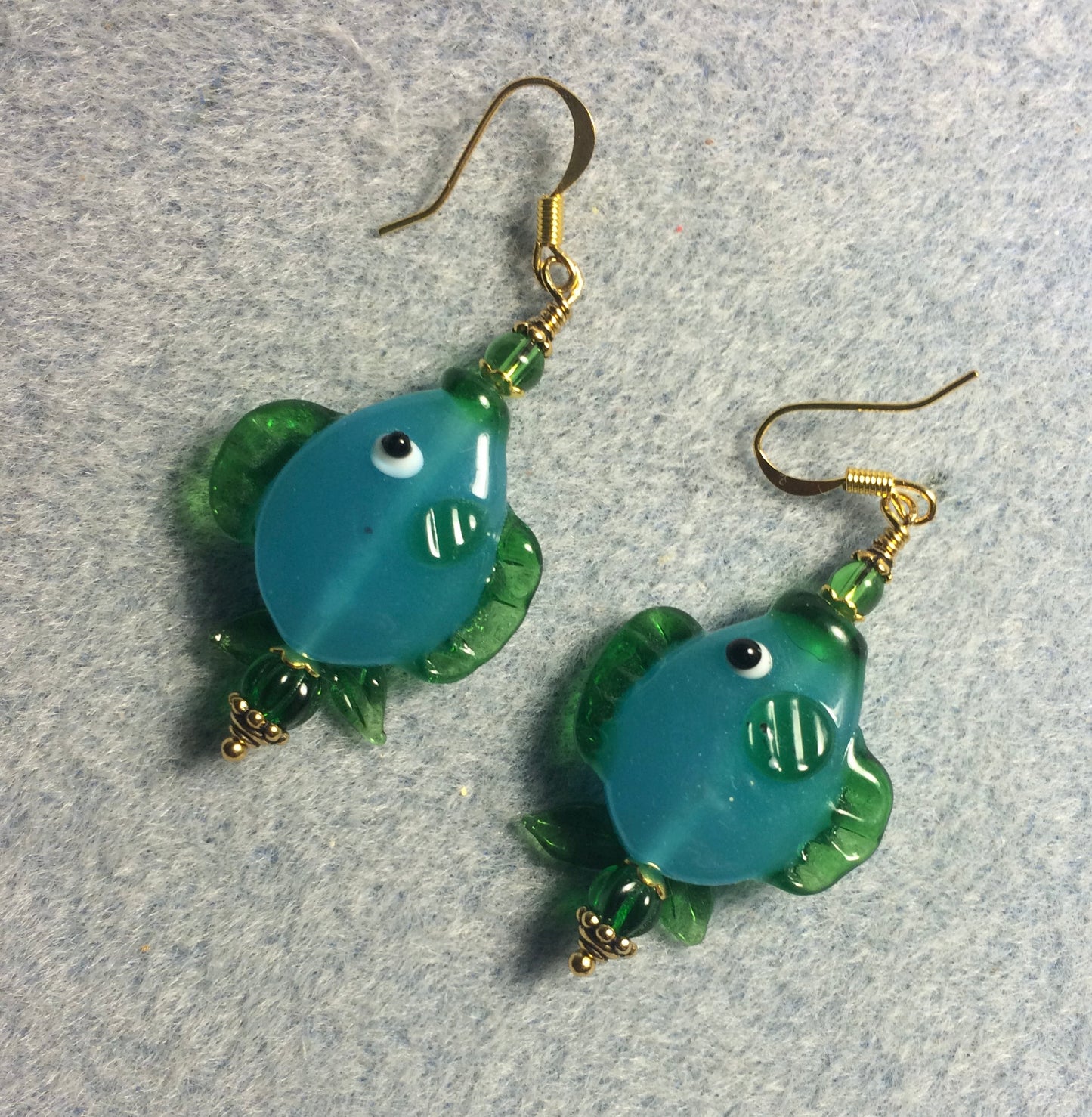 Turquoise and green lamp work fish bead earrings adorned with green Czech glass beads.