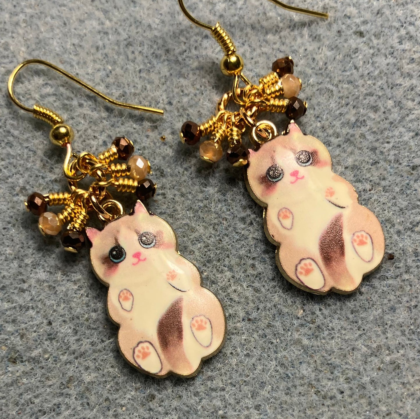 Brown and tan enamel cat charm earrings adorned with tiny dangling brown and tan Chinese crystal beads.