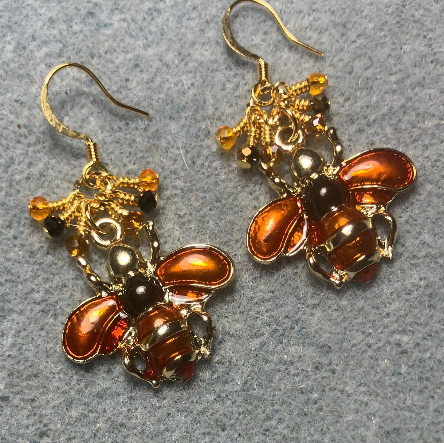 Orange and black enamel honeybee charm earrings adorned with tiny dangling orange and black Chinese crystal beads.
