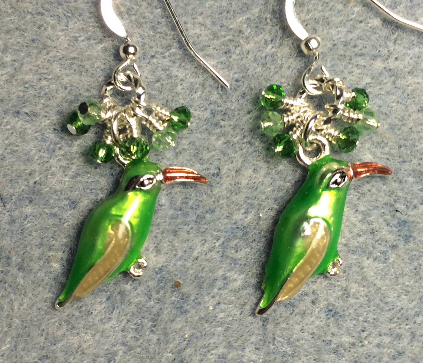 Green and amber enamel bird charm earrings adorned with tiny dangling green Chinese crystal beads.