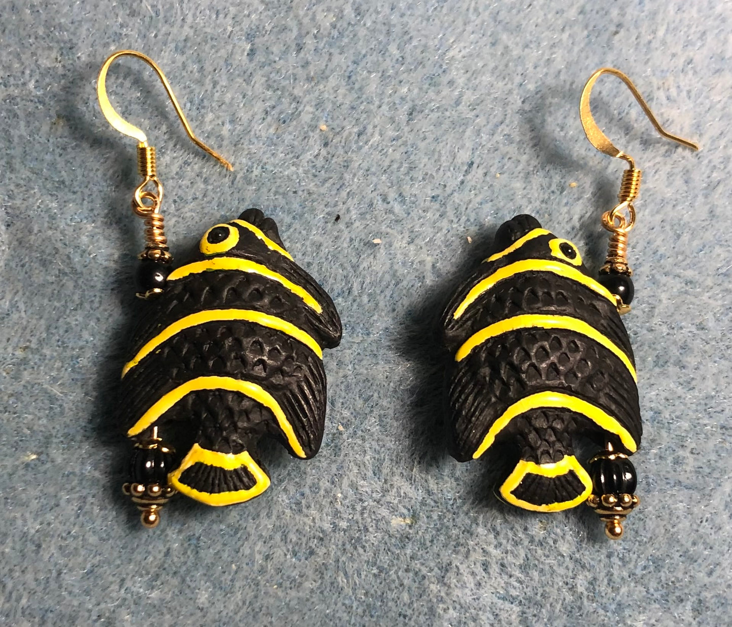 Black and yellow ceramic striped angelfish bead earrings adorned with black Czech glass beads.