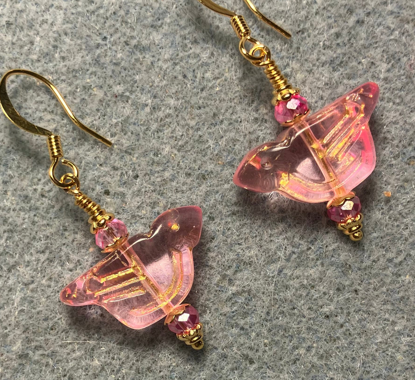 Translucent pink (with gold wash) Czech glass bird bead earrings adorned with pink Chinese crystal beads.