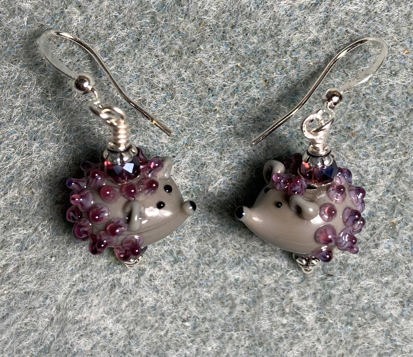 Small gray and purple lamp work hedgehog bead earrings adorned with purple Chinese crystal beads.
