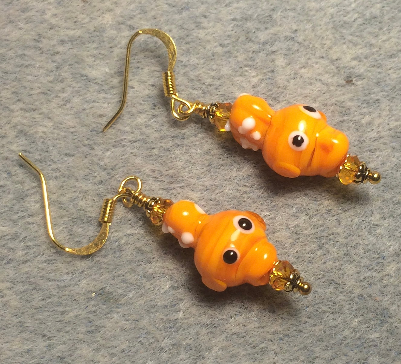 Small tangerine lamp work fish bead earrings adorned with tangerine Chinese crystal beads.