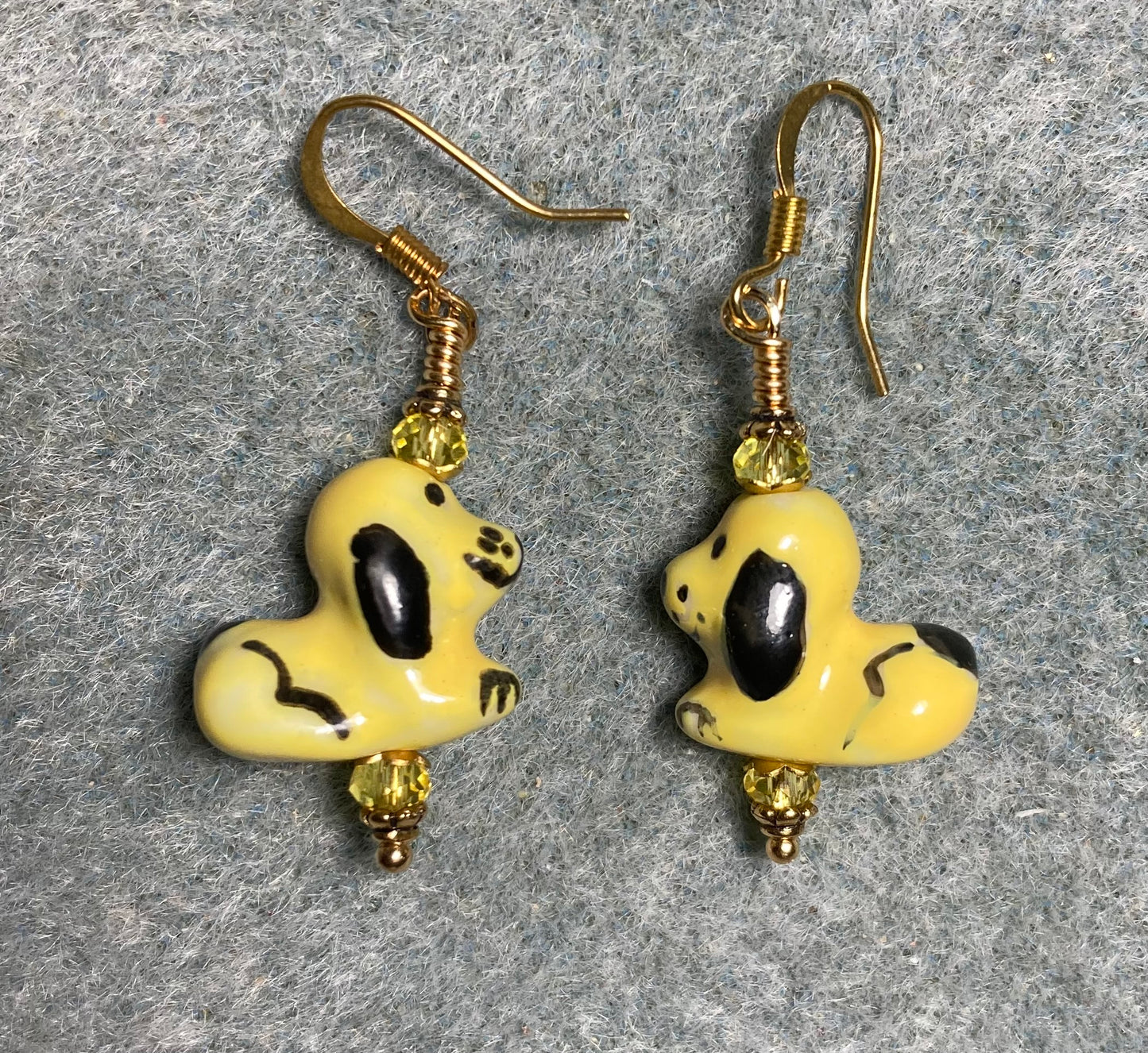 Yellow and black ceramic puppy dog bead earrings adorned with yellow Chinese crystal beads.