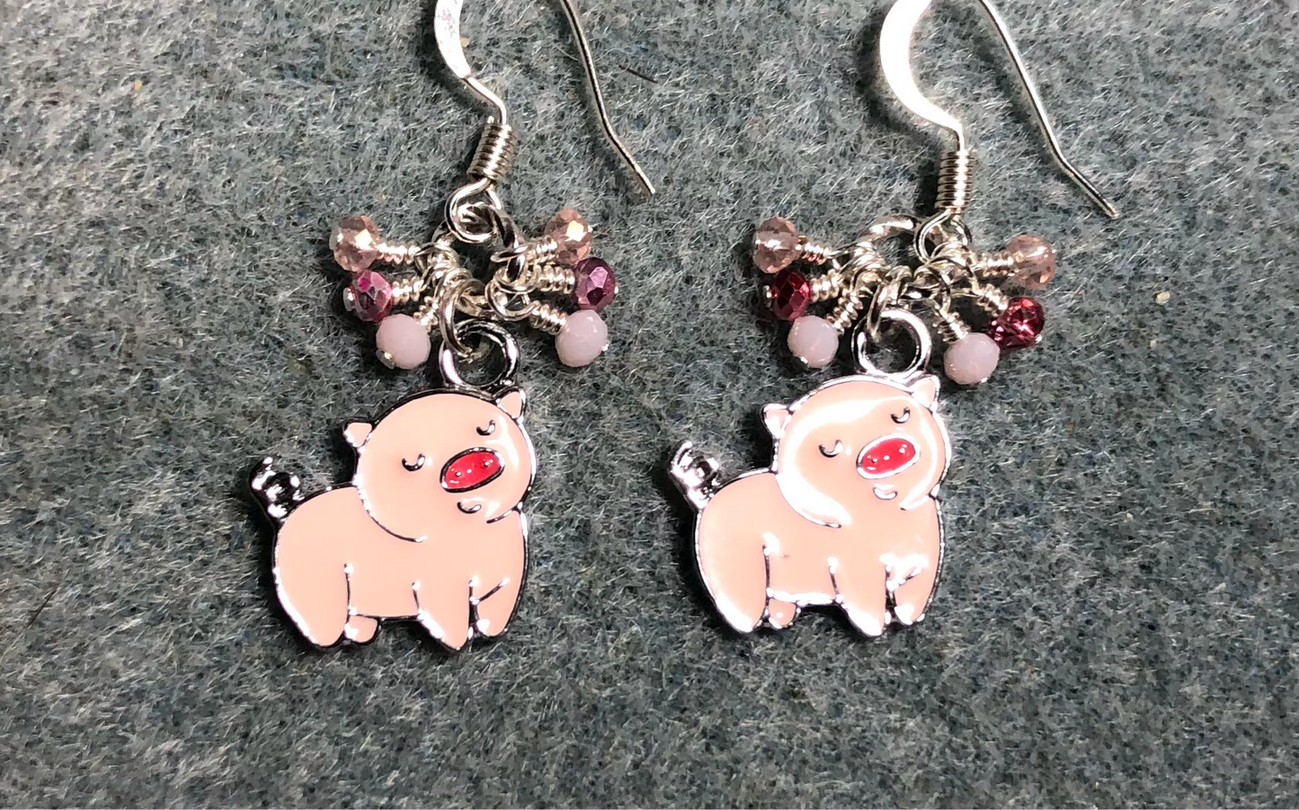 Light pink and dark pink enamel pig charm earrings adorned with tiny dangling light pink and dark pink Chinese crystal beads.