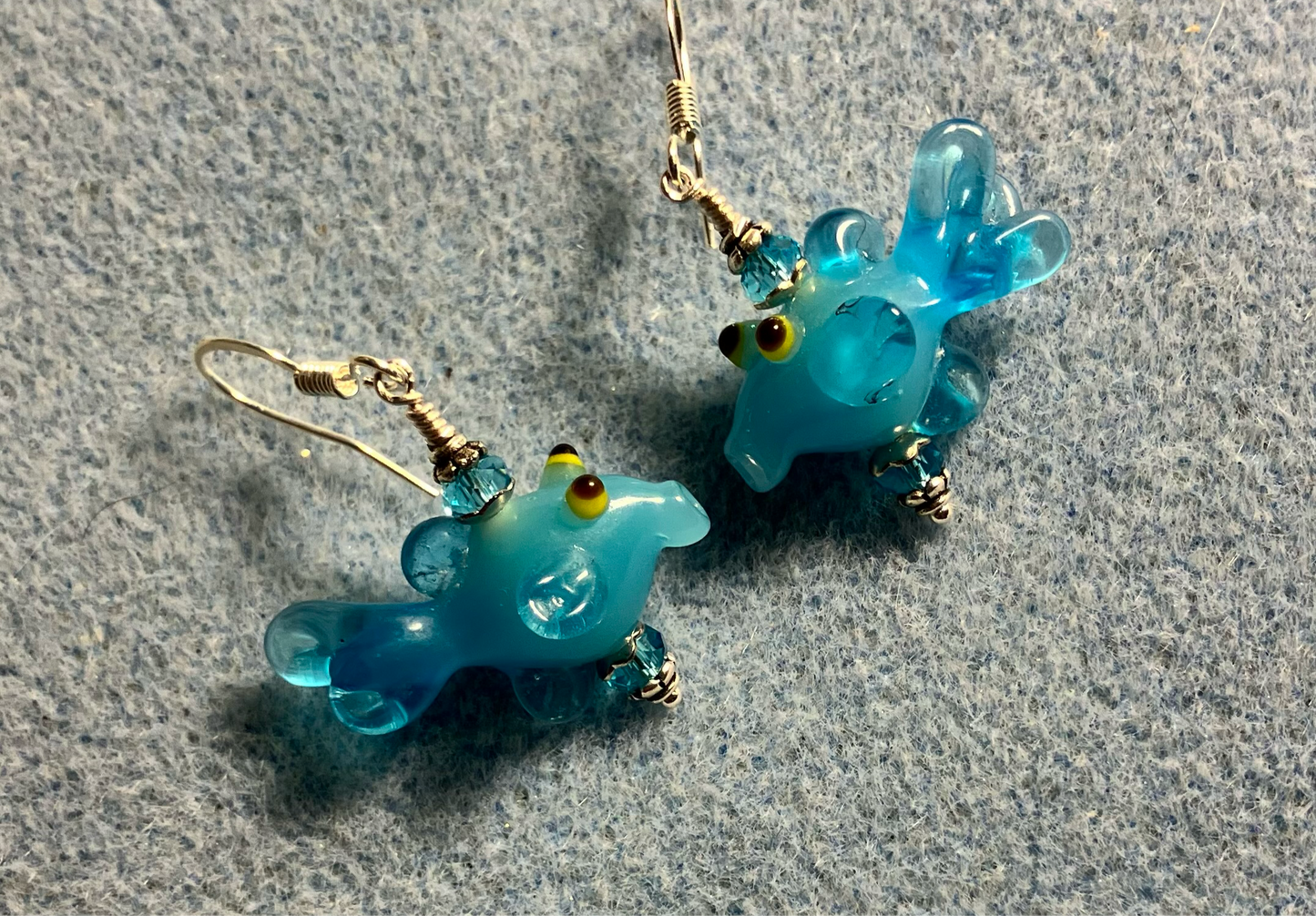 Turquoise lamp work fish bead earrings adorned with turquoise Chinese crystal beads.